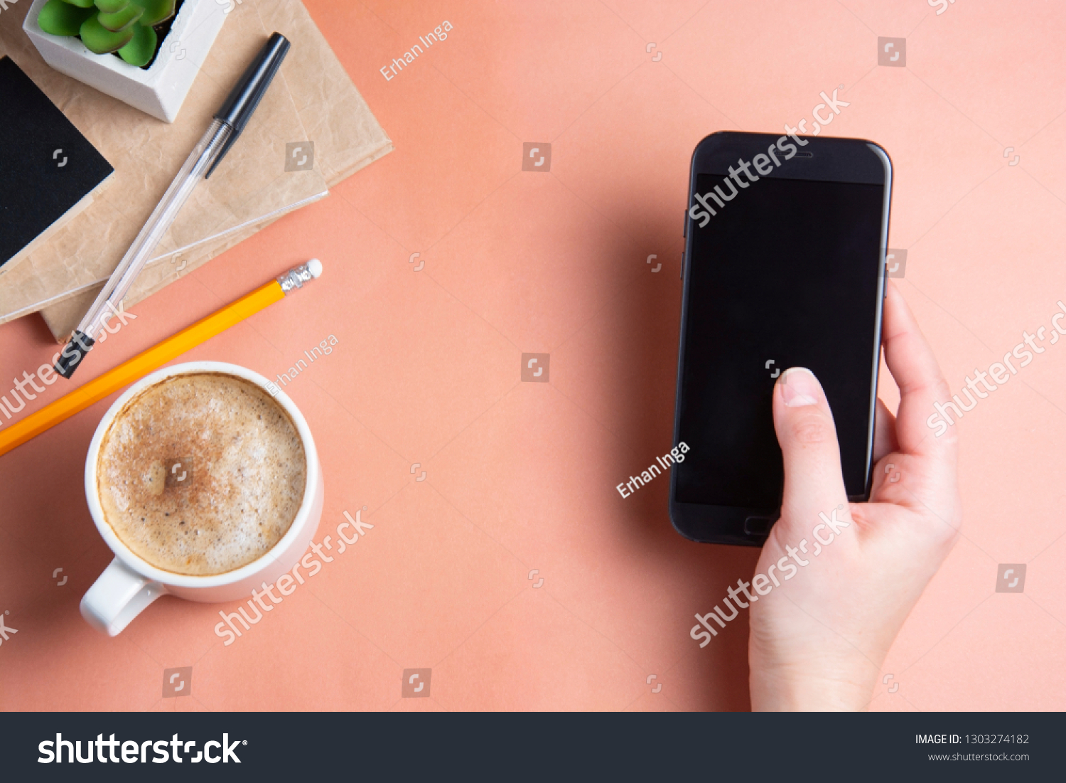 Woman's hands holding, using smarphone. Work place, work table with coffee cup. Top view, copy space. #1303274182