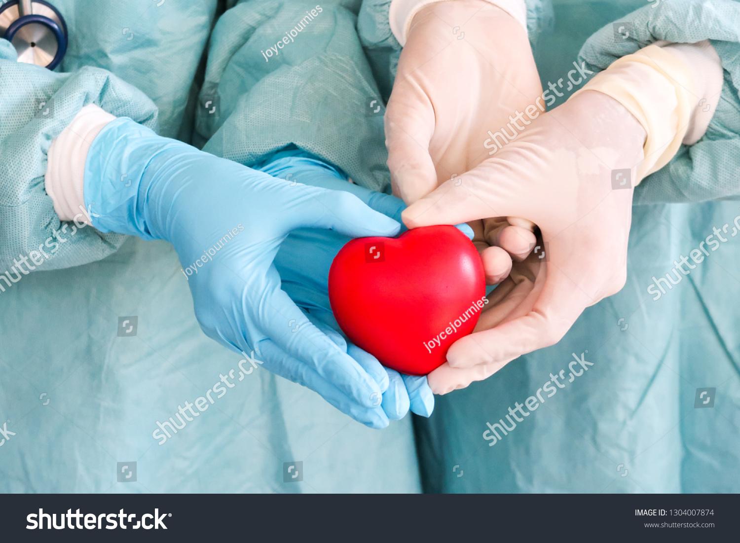 One hand of many doctors holding a red heart balloon, heart health care, loved ones #1304007874