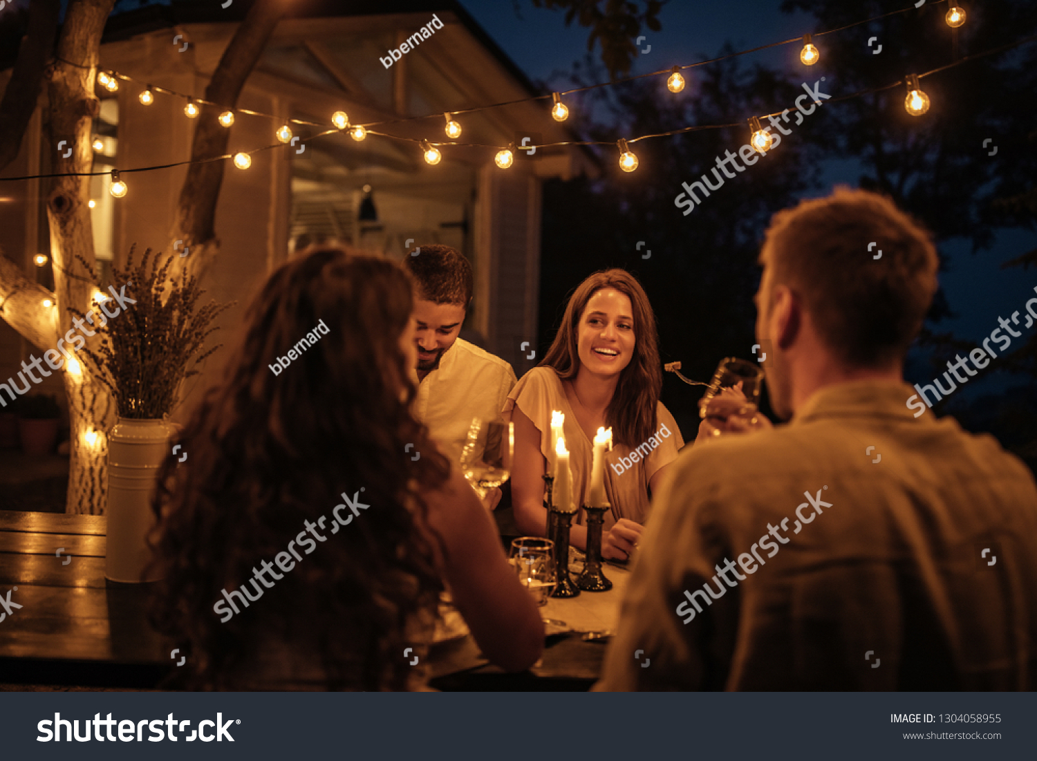 Shot of friends having fun at a dinner party in a backyard #1304058955
