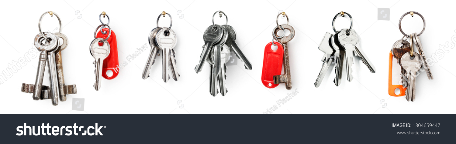 Key ring with house door keys collection isolated on white background. Banner design element security concept #1304659447