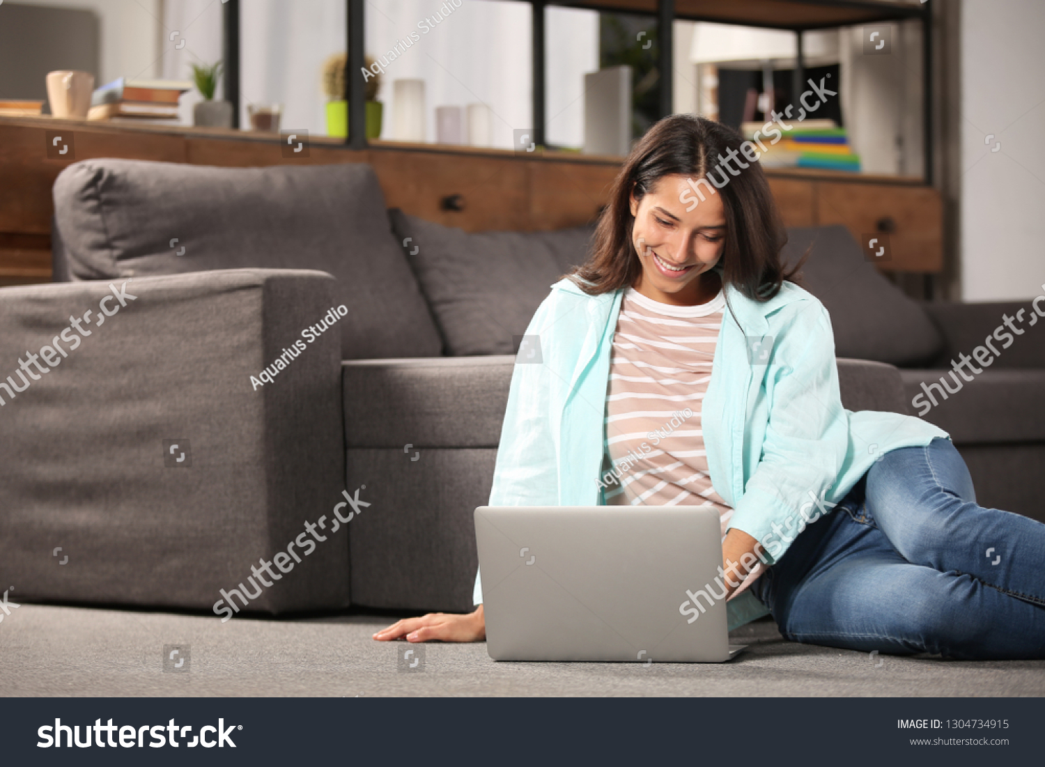 Young woman working with laptop at home #1304734915