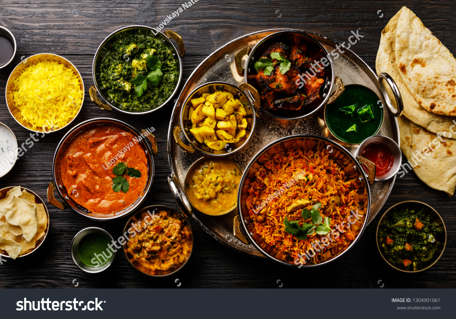 Indian food Curry butter chicken, Palak Paneer, Chiken Tikka, Biryani, Vegetable Curry, Papad, Dal, Palak Sabji, Jira Alu, Rice with Saffron on dark background #1304901061