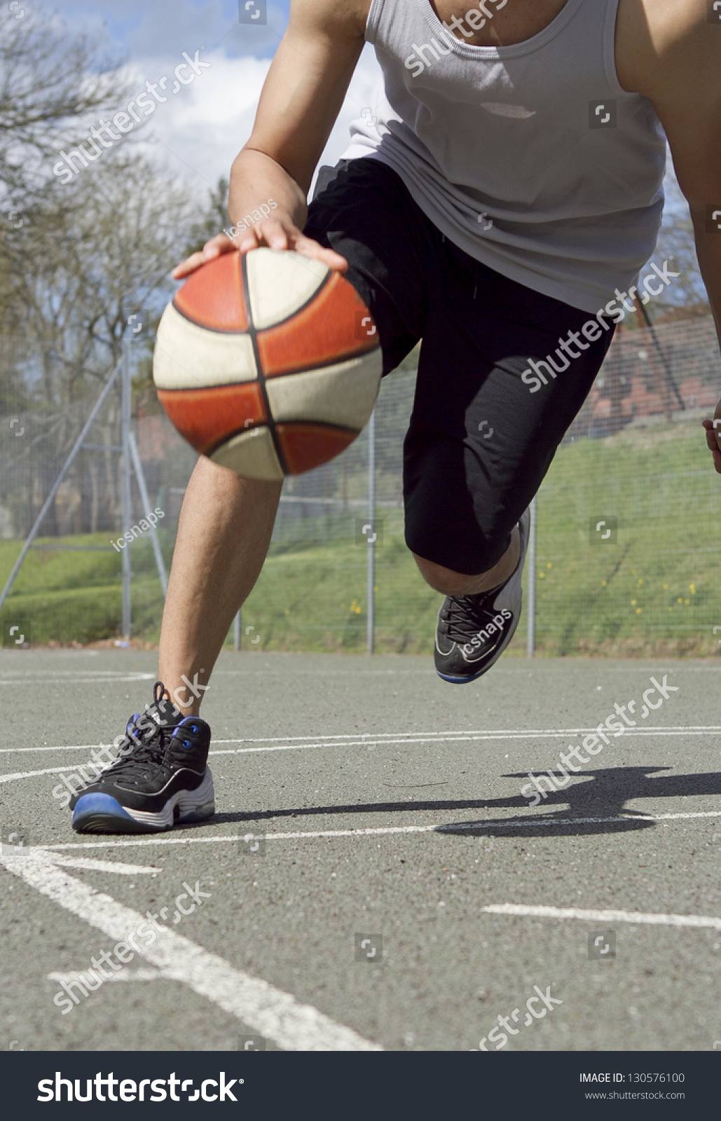 Portrait of Basketball Player dribbling the ball in Motion #130576100