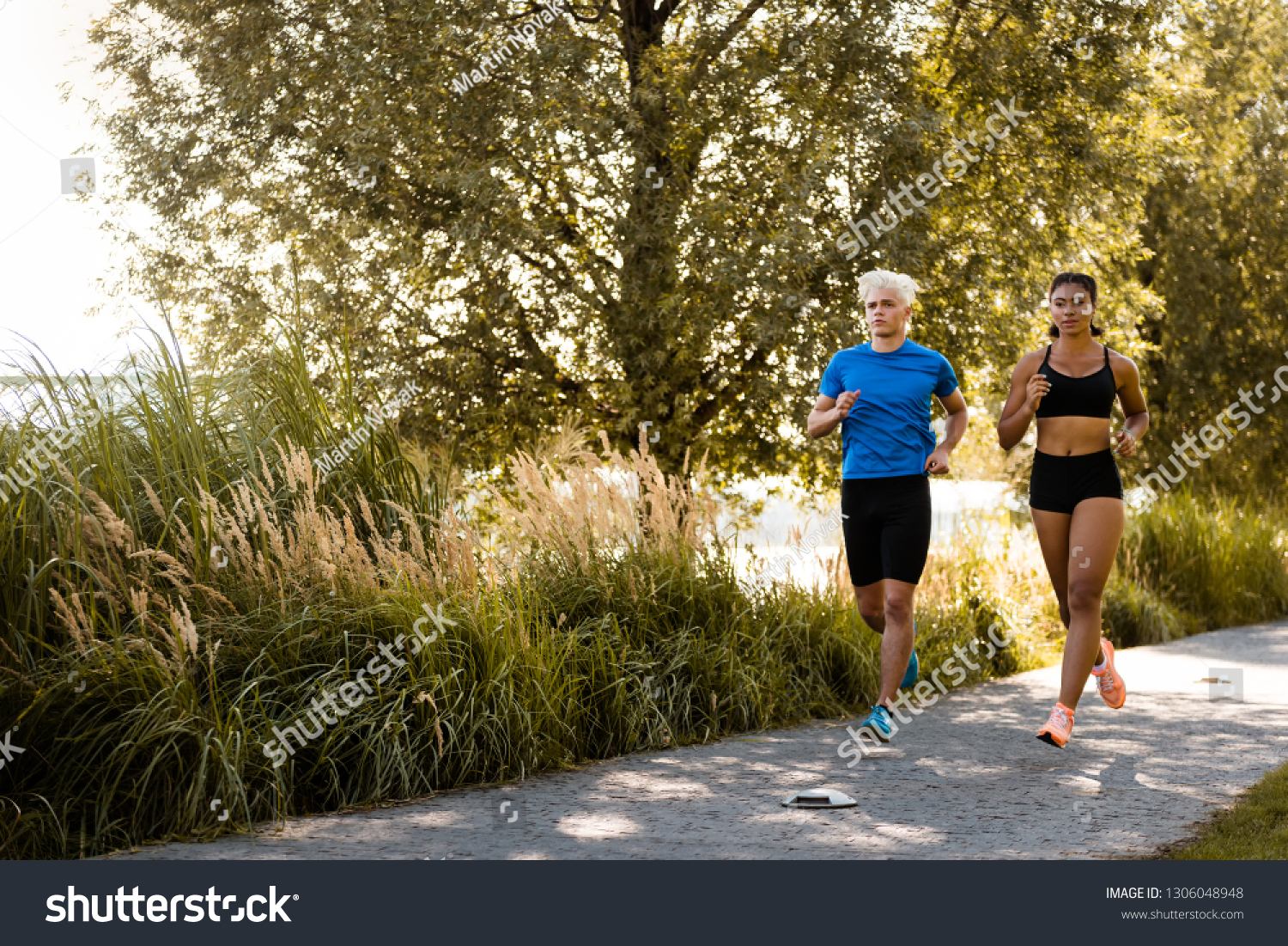 Multi-ethnic joggers exercising together outside in park #1306048948