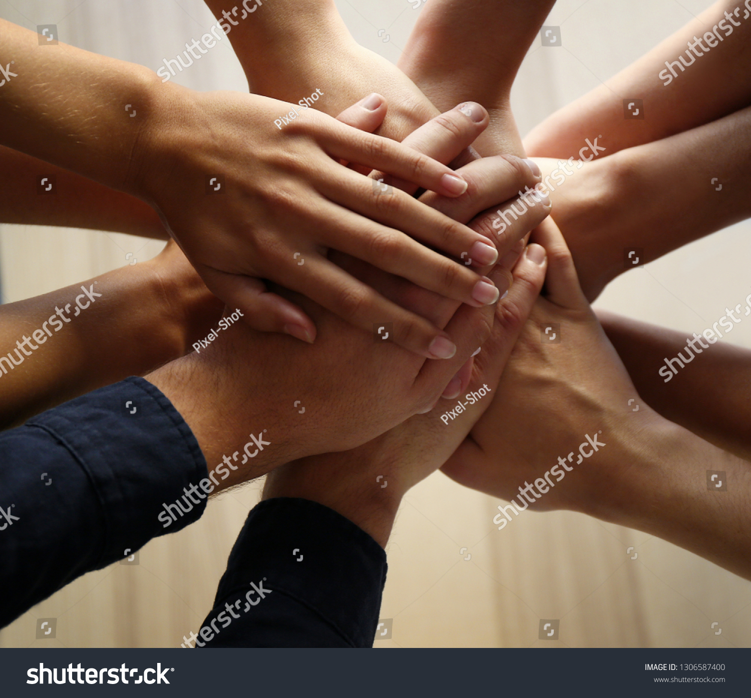 People putting hands together, closeup. Unity concept #1306587400