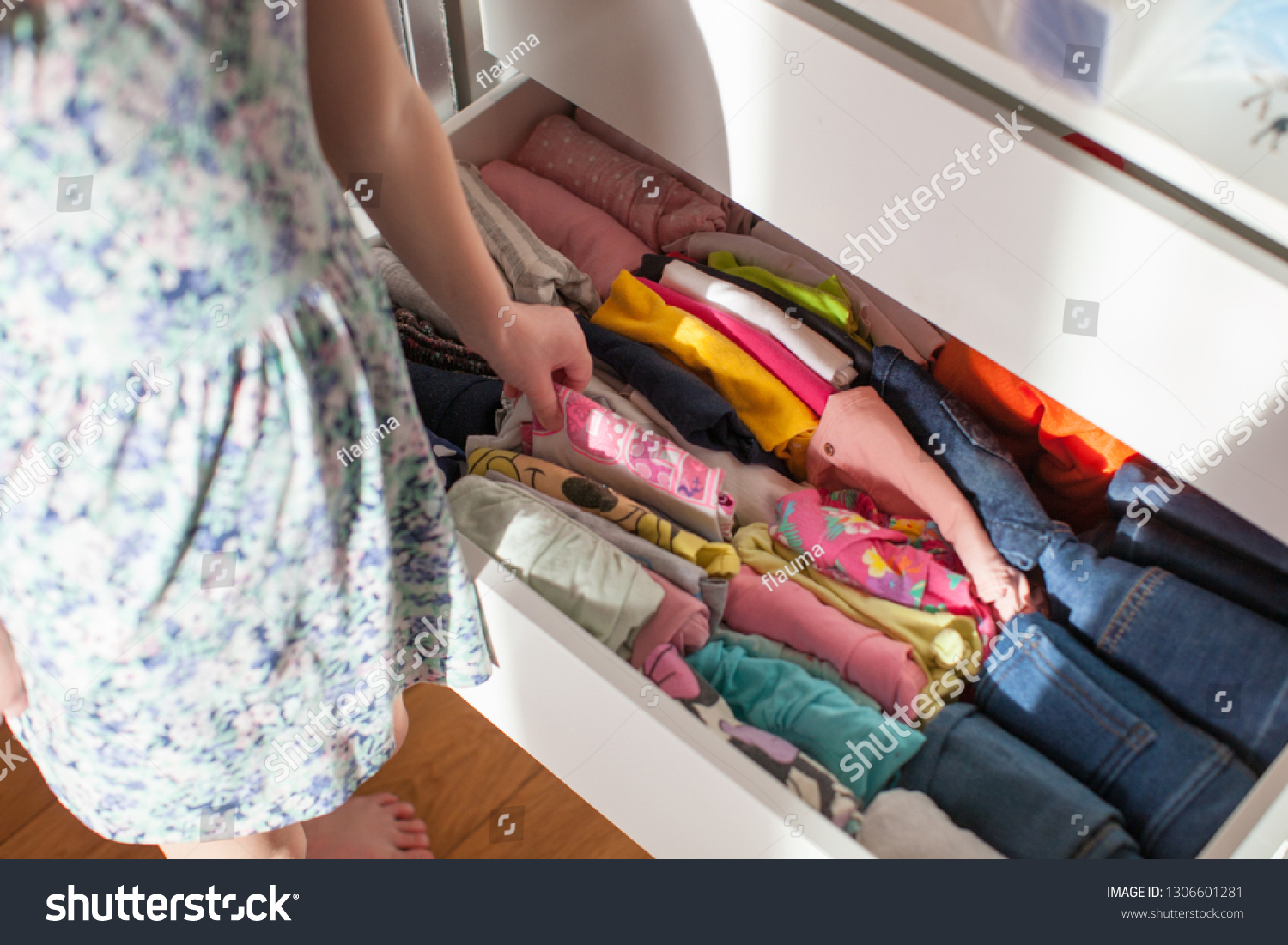 Vertical storage of clothing. Clothing folded for vertical storage in the linen drawer. #1306601281