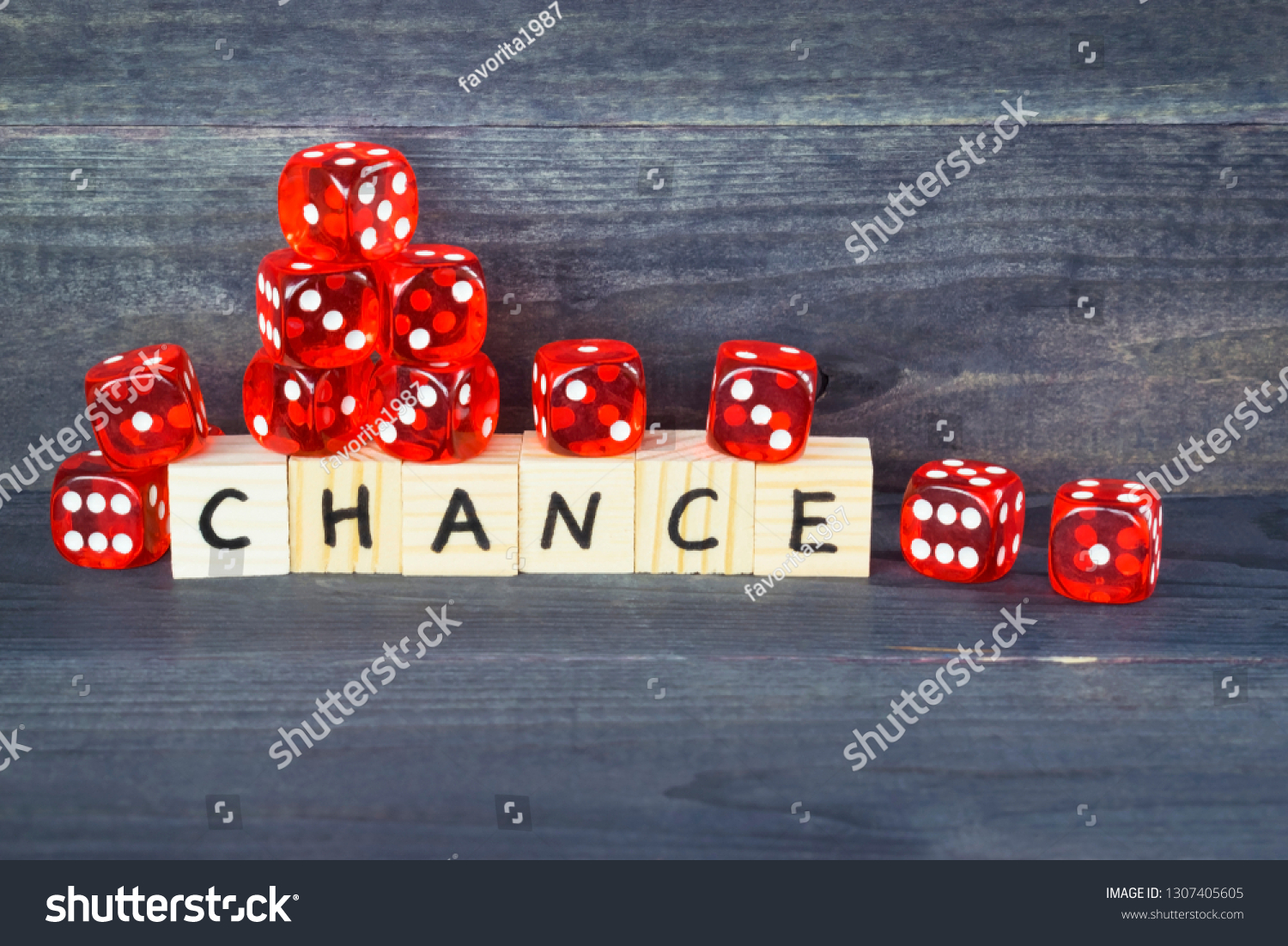 Word Chance written on wooden cubes and red dice on the dark background.  #1307405605