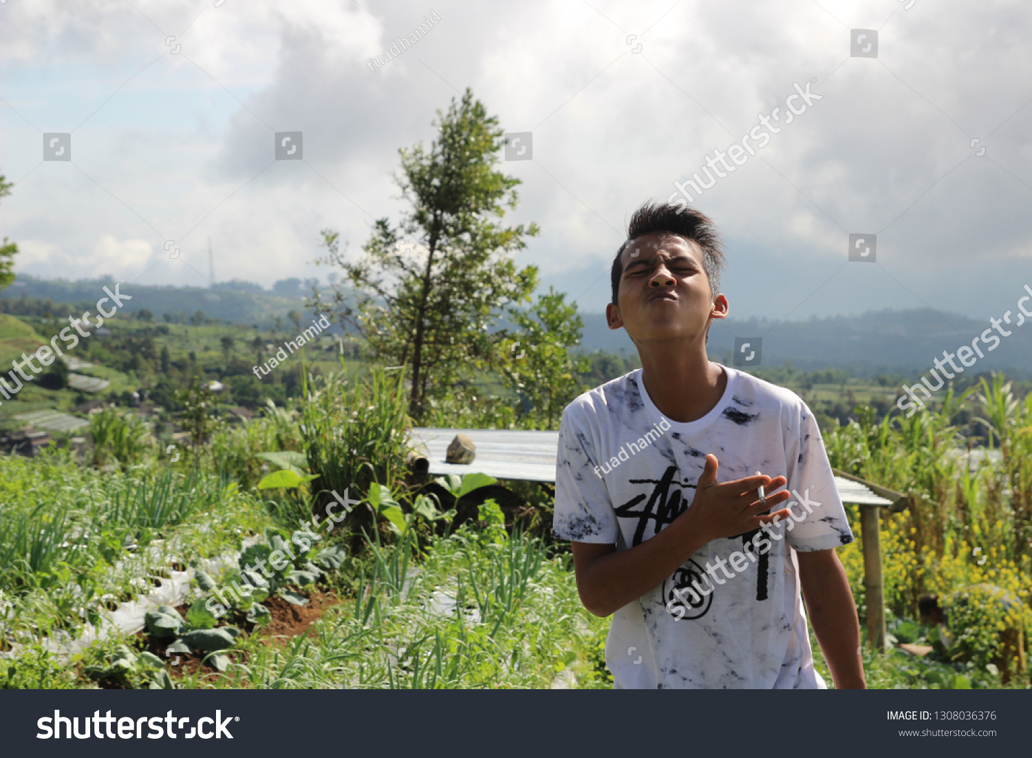 teenagers play on the hill to see the sights and see clouds, in magelang indonesia 3 february 2019 #1308036376