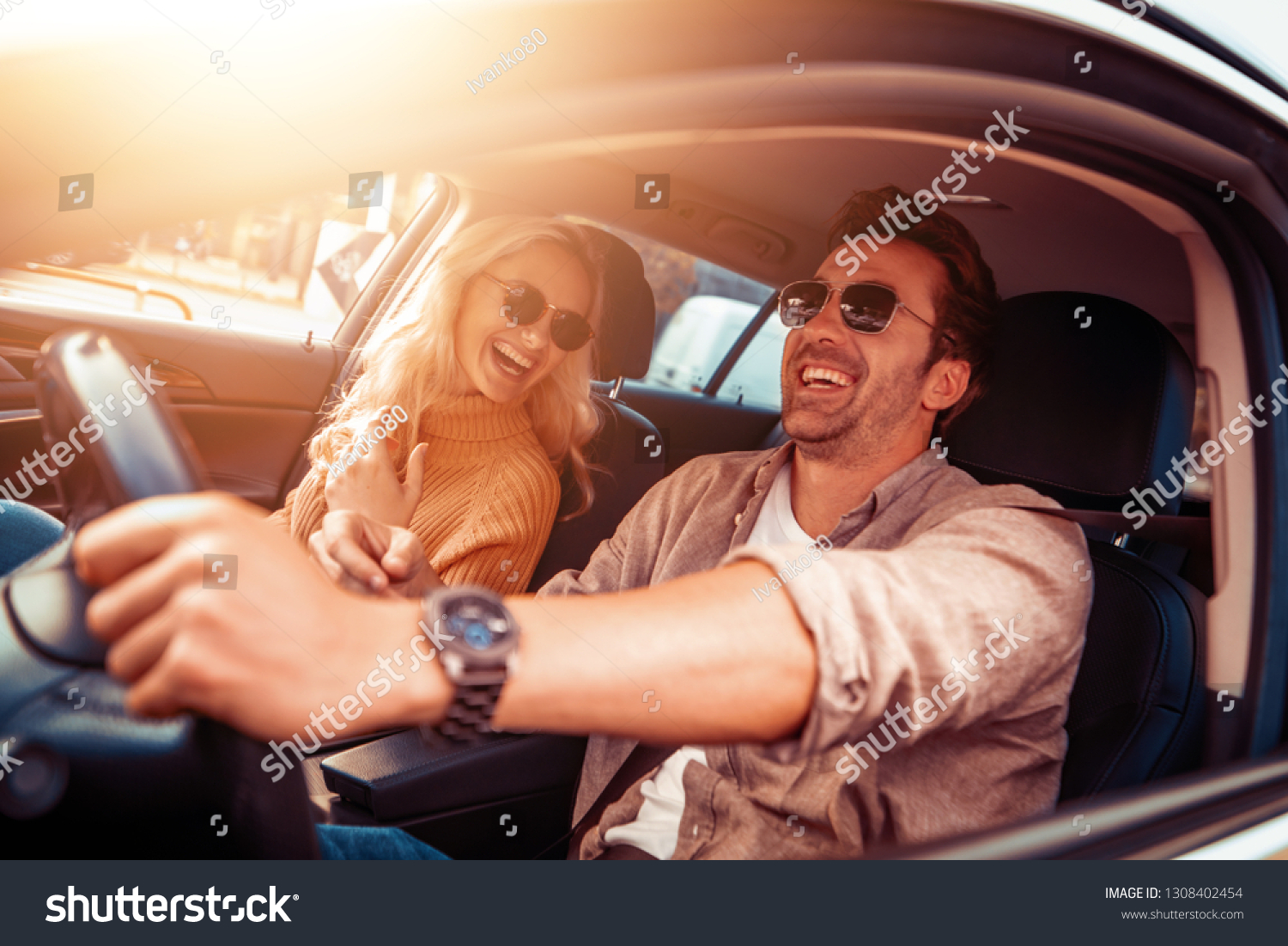 Happy young couple enjoying on a long drive in a car. #1308402454