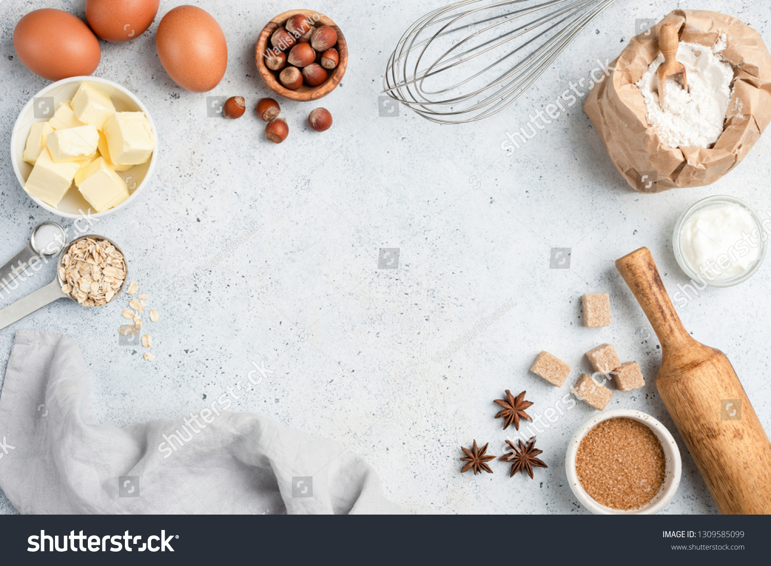 Baking ingredients and utensils on concrete background. Cooking or baking cake, cookies, pastry or bread concept. Top view with copy space for text, recipe, menu #1309585099