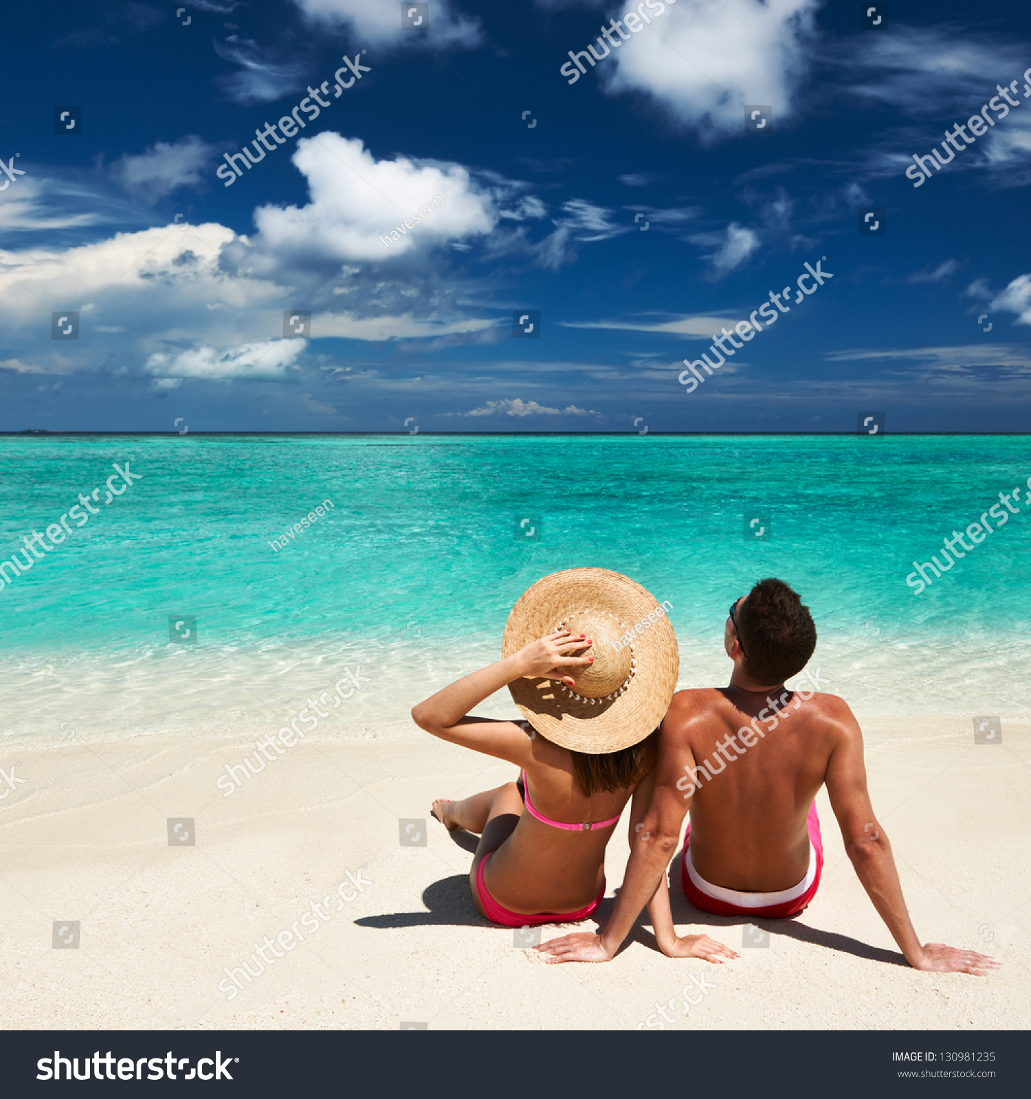 Couple on a tropical beach at Maldives #130981235