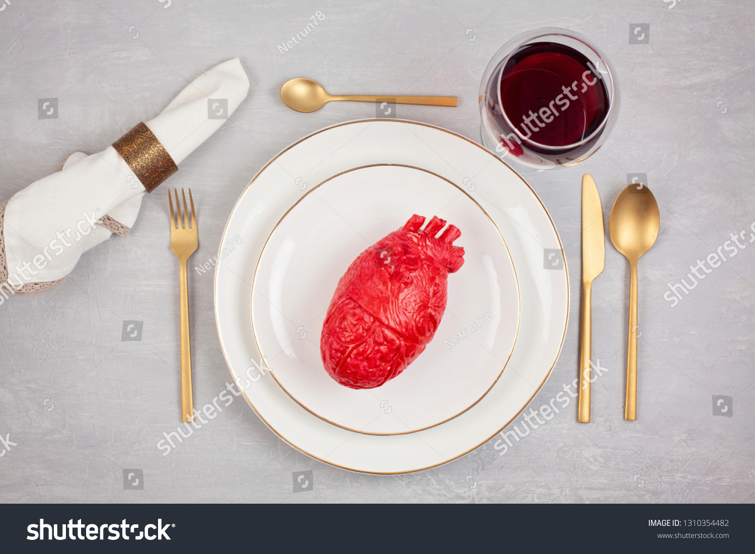 Realistic heart on the dining table in the plate. Love, marriage, proposal, heartbreaker humoristic concept #1310354482