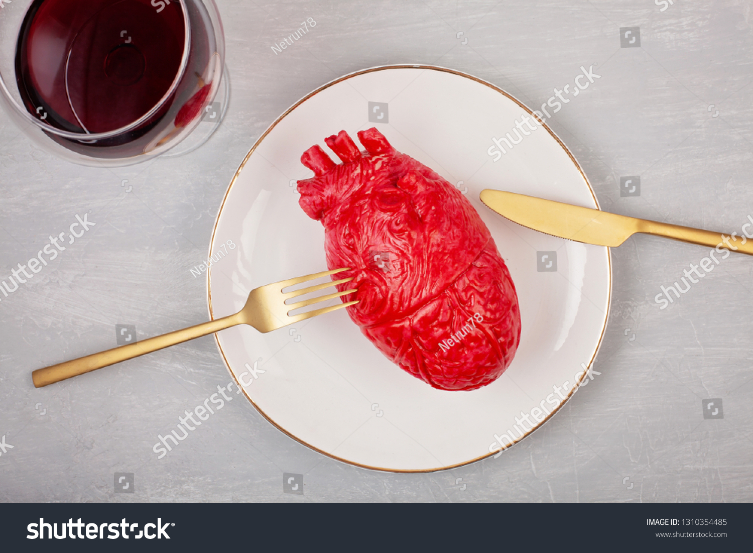 Realistic heart on the dining table in the plate. Love, marriage, proposal, heartbreaker humoristic concept #1310354485