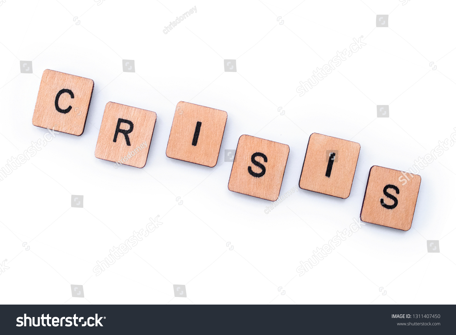 The word CRISIS, spelt with wooden letter tiles. #1311407450