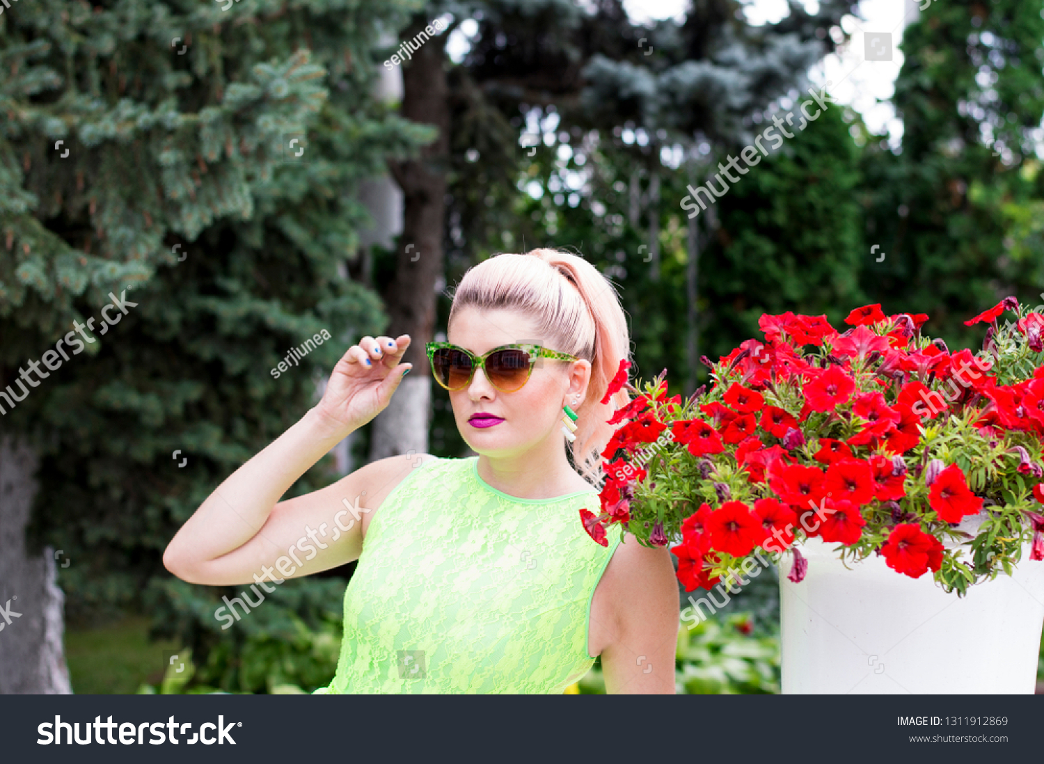 beautiful woman and beautiful Petunia, beautiful bright women summer theme and flowers #1311912869