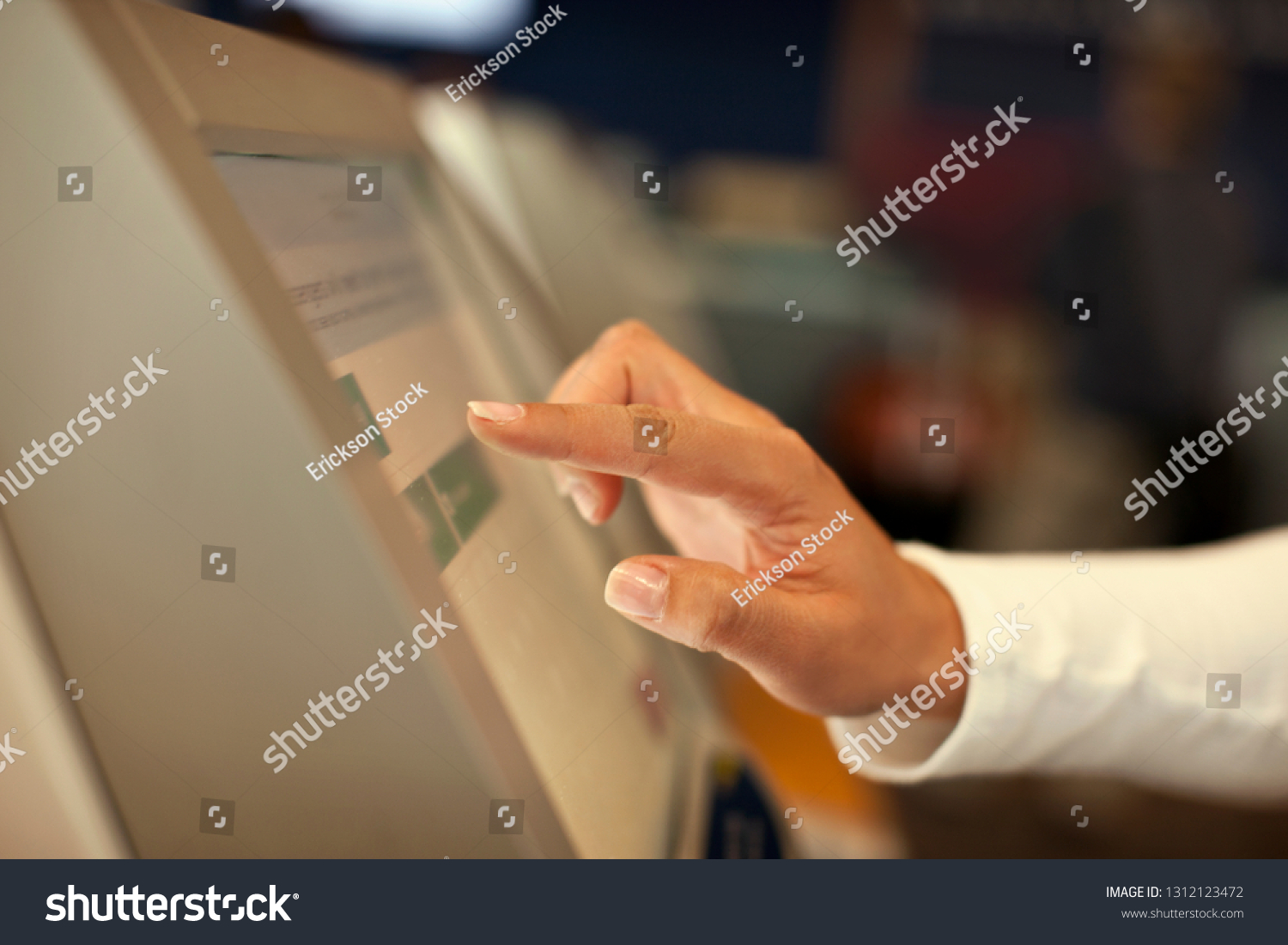 Hand of a mid adult man using a touch screen. #1312123472