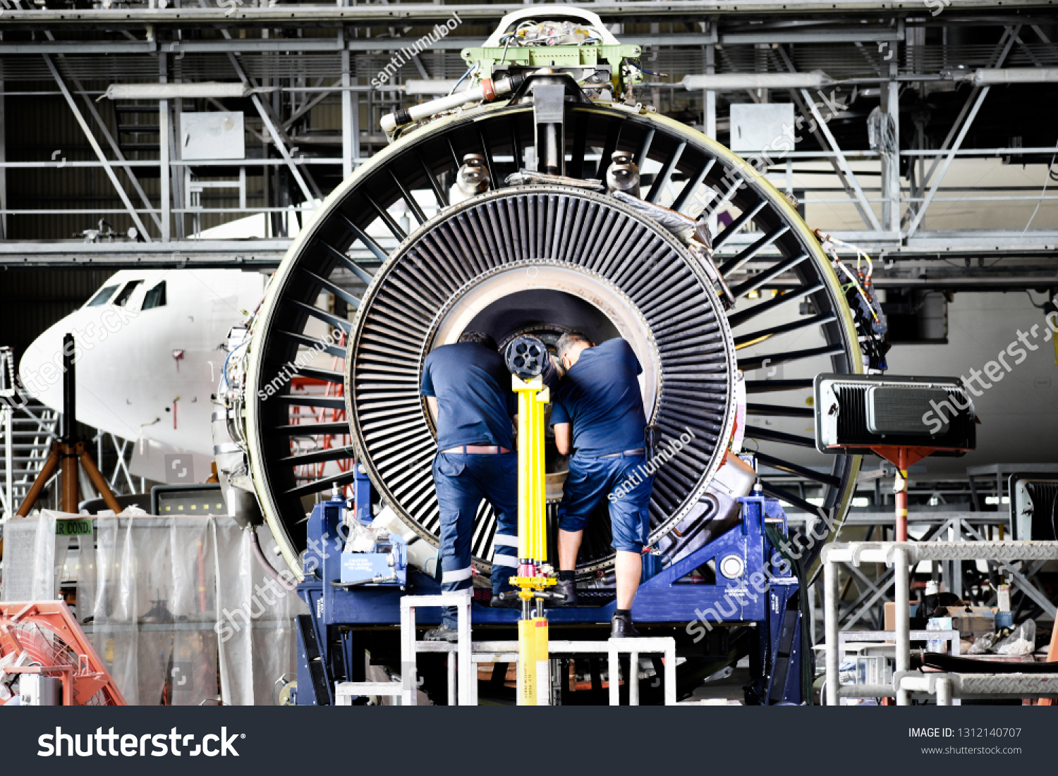 Jet engine remove from aircraft (airplane) for maintenance at aircraft hangar.Jet engine maintenance and change part by aircraft technician . #1312140707