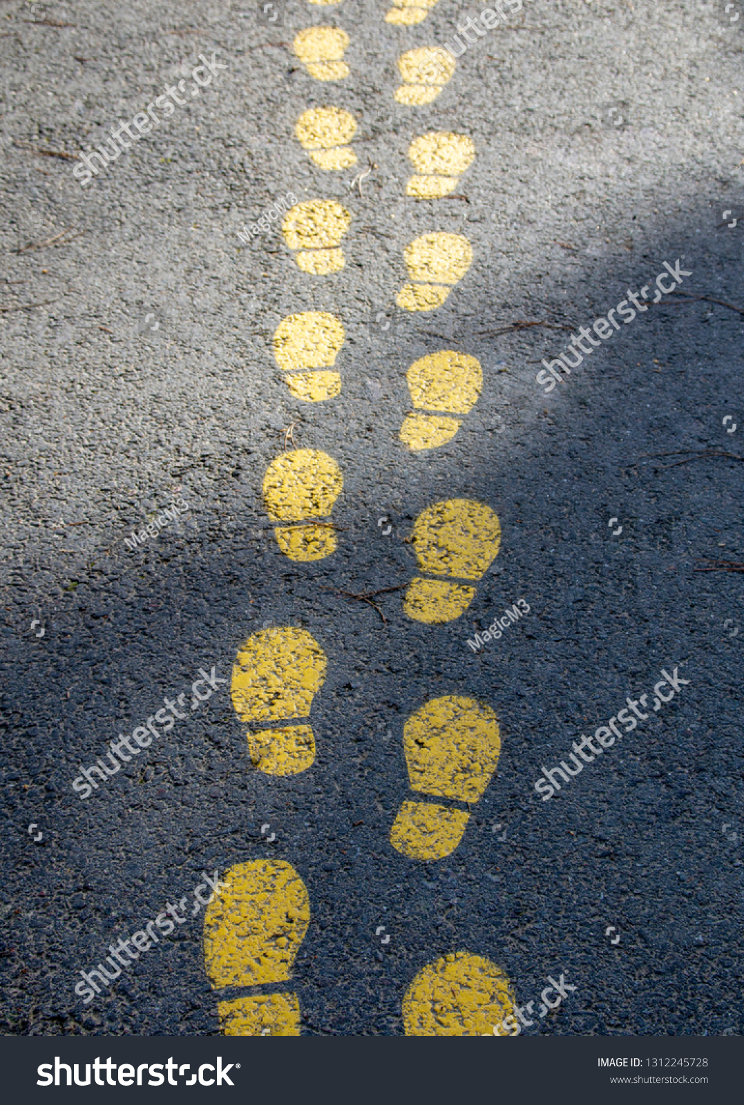 foot pattern on asphalt, indicates the way #1312245728