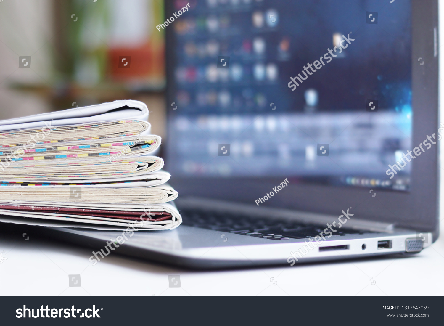 Newspapers and Laptop. Magazines and Journals and Computer. Paper Media and Electronic Device with Internet - Business News and Financial Information. Headlines, Articles and Digital Content #1312647059