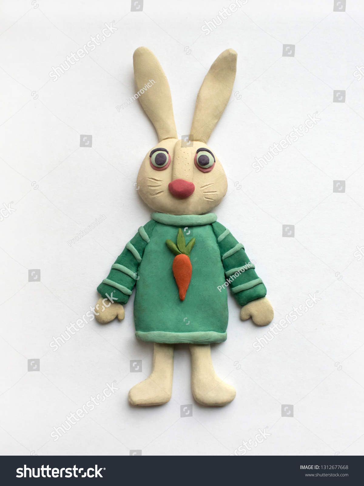 Cute hare in a blue dress. Plasticine character on a white background #1312677668