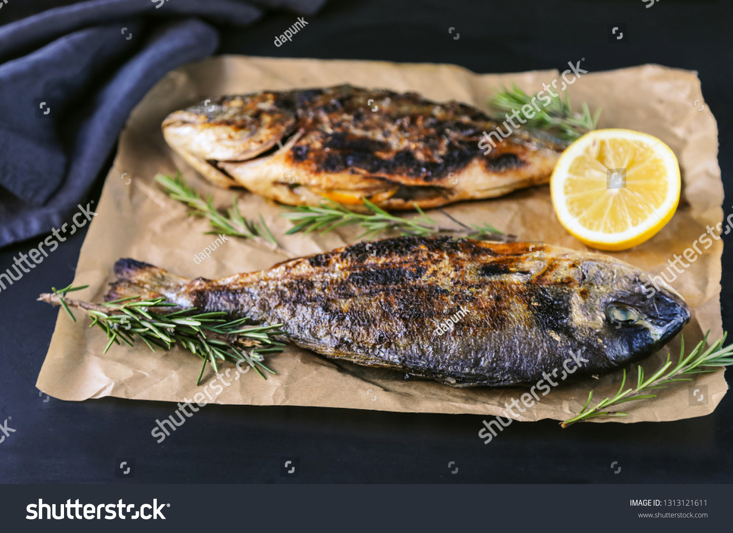 Grilled bream fish with herbs and spices on black background. #1313121611