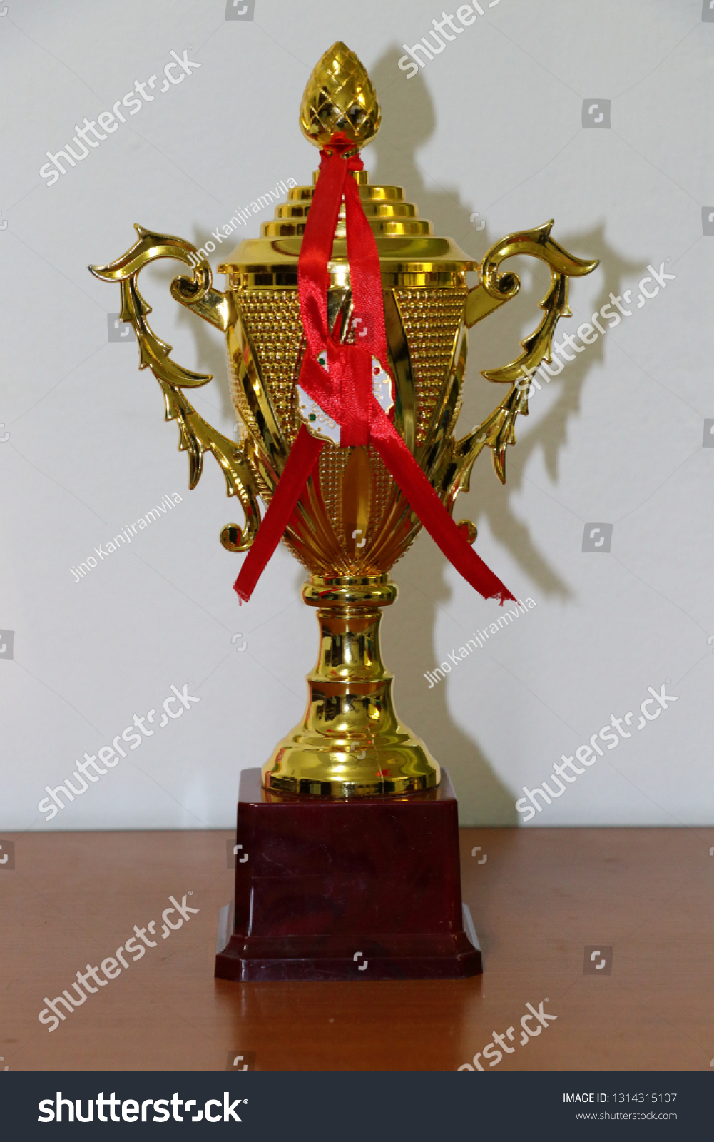 champion golden trophy on wood table with copy space, copy space ready for your design #1314315107