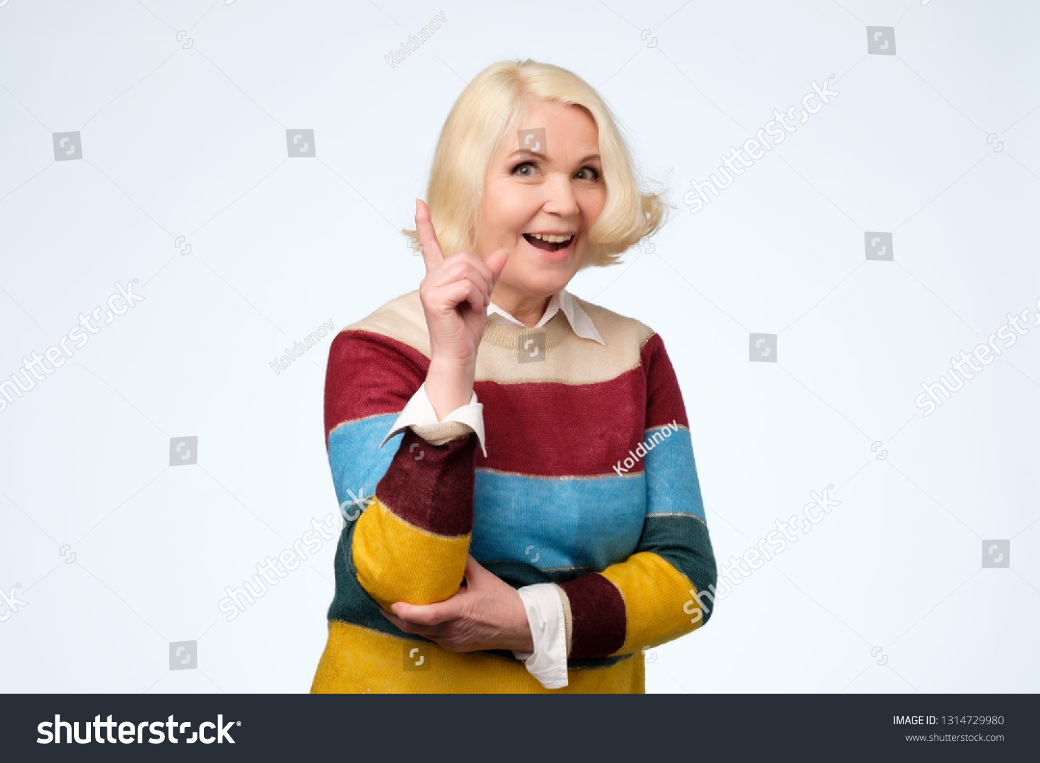 emotional expressive grandmother pointing with index finger up #1314729980