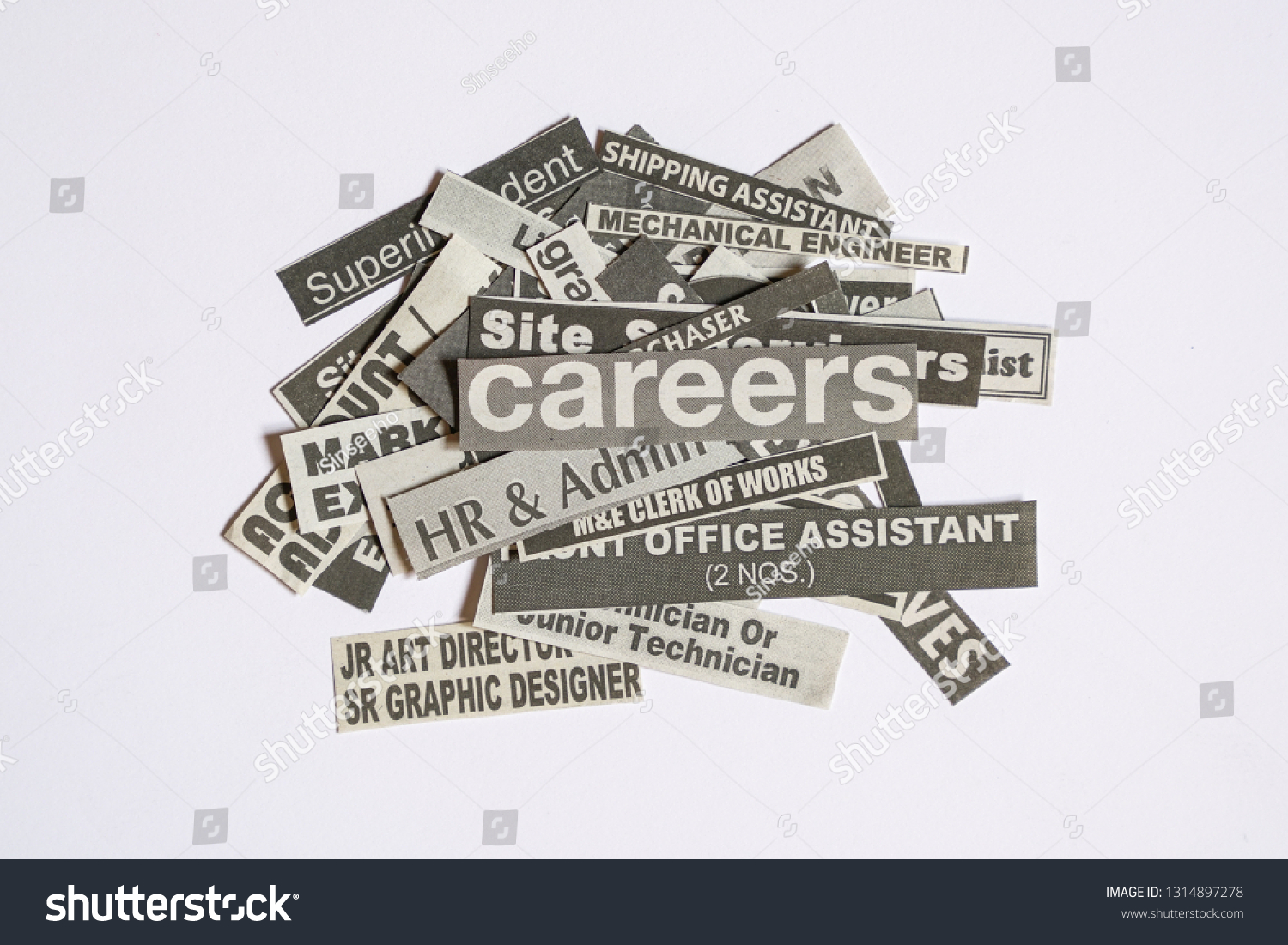 Jobs or careers concept: job titles or occupations cut off from newspaper and with Careers on top of the pile #1314897278