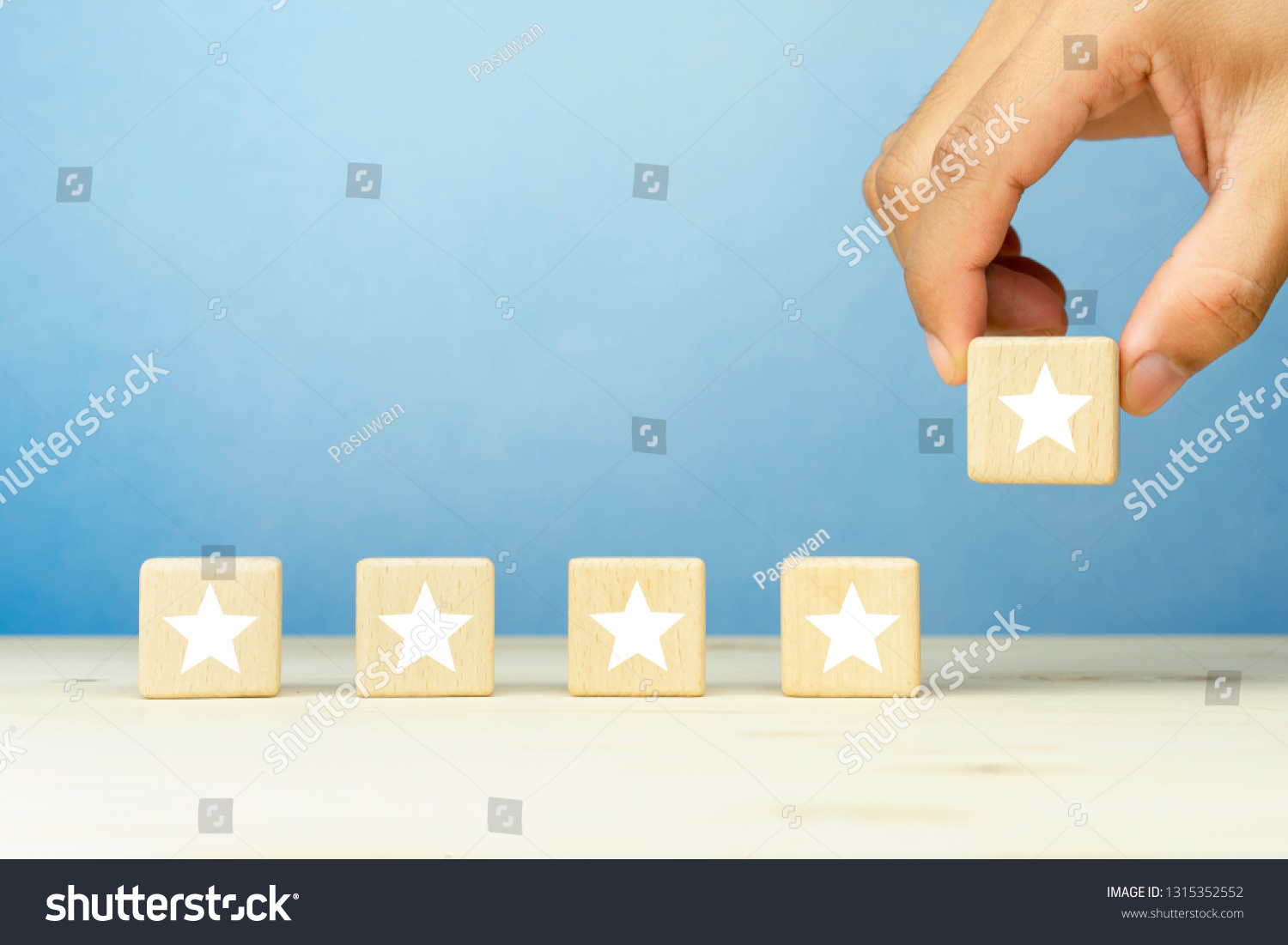 The client's hand put wooden blocks with a five star symbol, evaluation, Increase rating, Customer experience, satisfaction and best excellent services rating concepts. copy space #1315352552