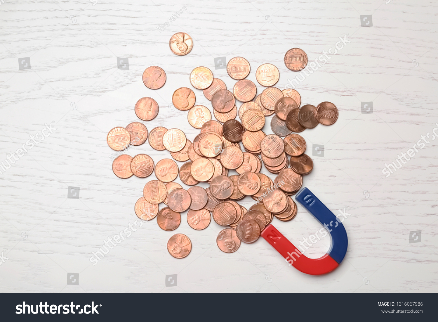 Magnet attracting coins on wooden background, top view. Business concept #1316067986