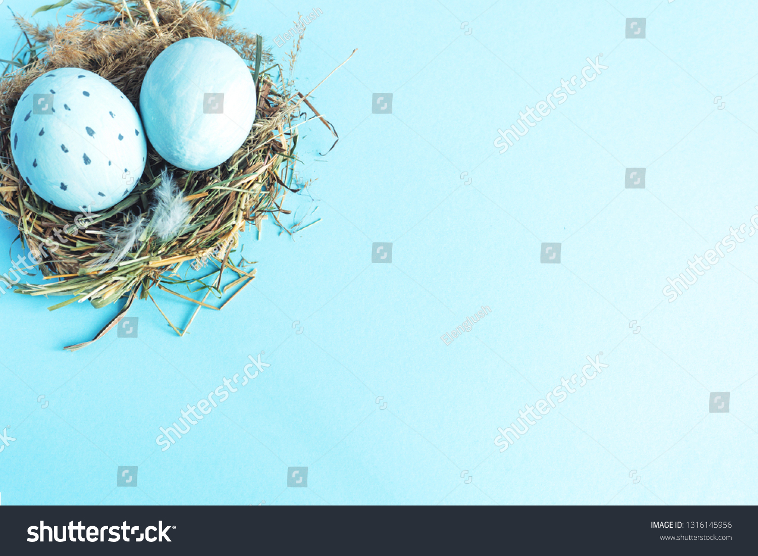 Easter eggs in a nest of grass. Blue background Copy space #1316145956