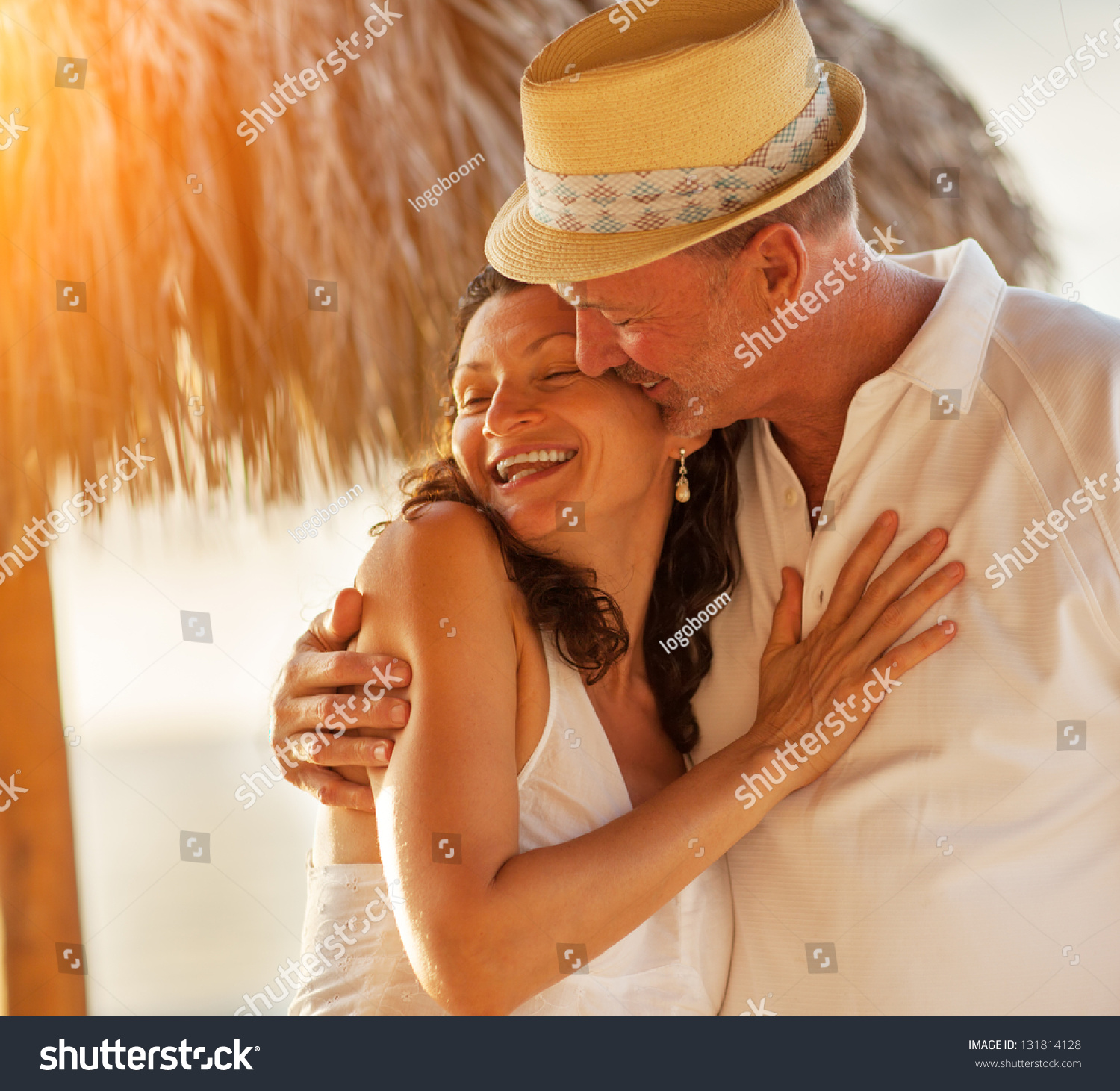 Happy Caucasian mature senior adult couple kiss on tropical beach, closeup. #131814128
