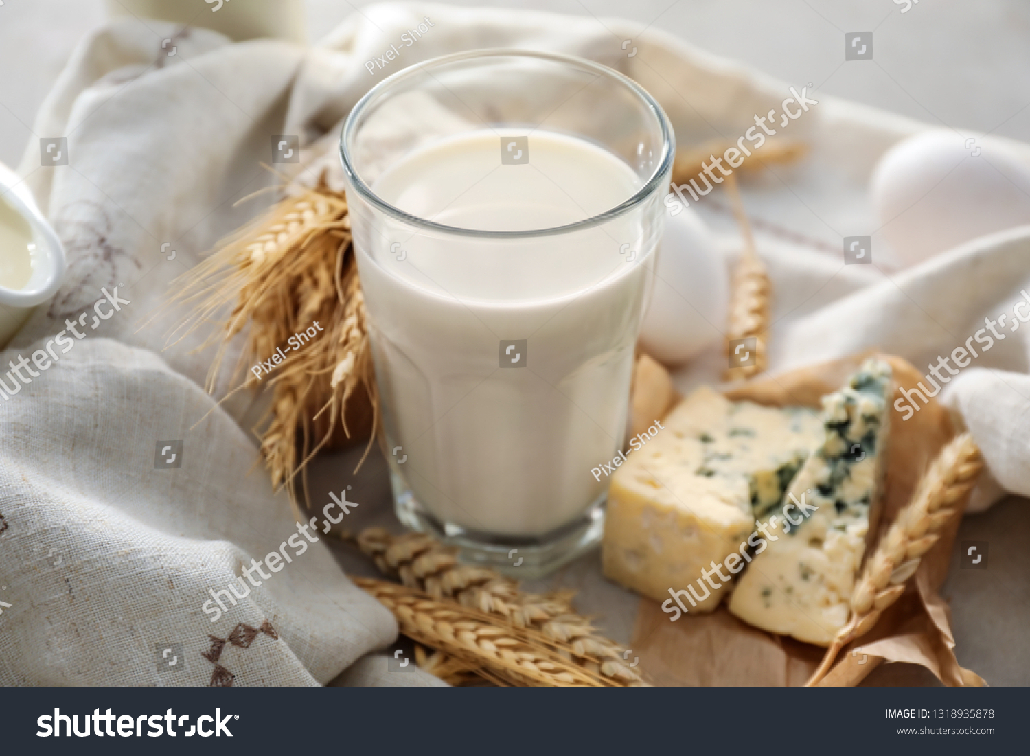 Glass of milk with cheese on grey table #1318935878