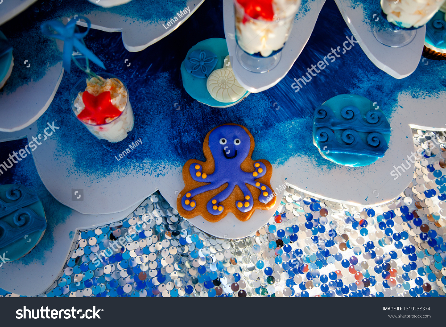 Homemade homemade gingerbread cookies in the form of crab, turtile, octopus and a starfish on the wooden table. Space for text and selective focus. #1319238374