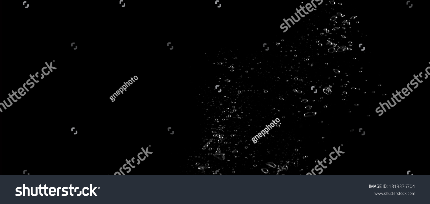 Extream close-up images of water bubbles or soda or liquid texture that splashing and floating up to surface like a explosion in black color background for refreshing carbonate drink concept. #1319376704