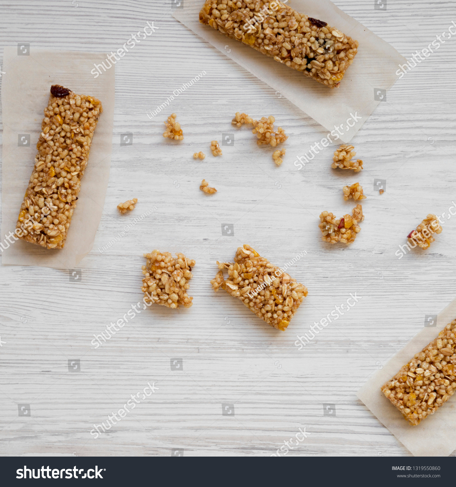 Granola bars on baking sheet on a white wooden table, top view. Overhead, from above, overhead. #1319550860