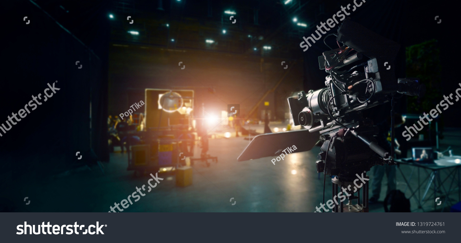 Behind the scenes of making of movie and TV commercial. Camera of movie and video production. Film Crew. B-roll, and crew team in studio and set on dark background #1319724761