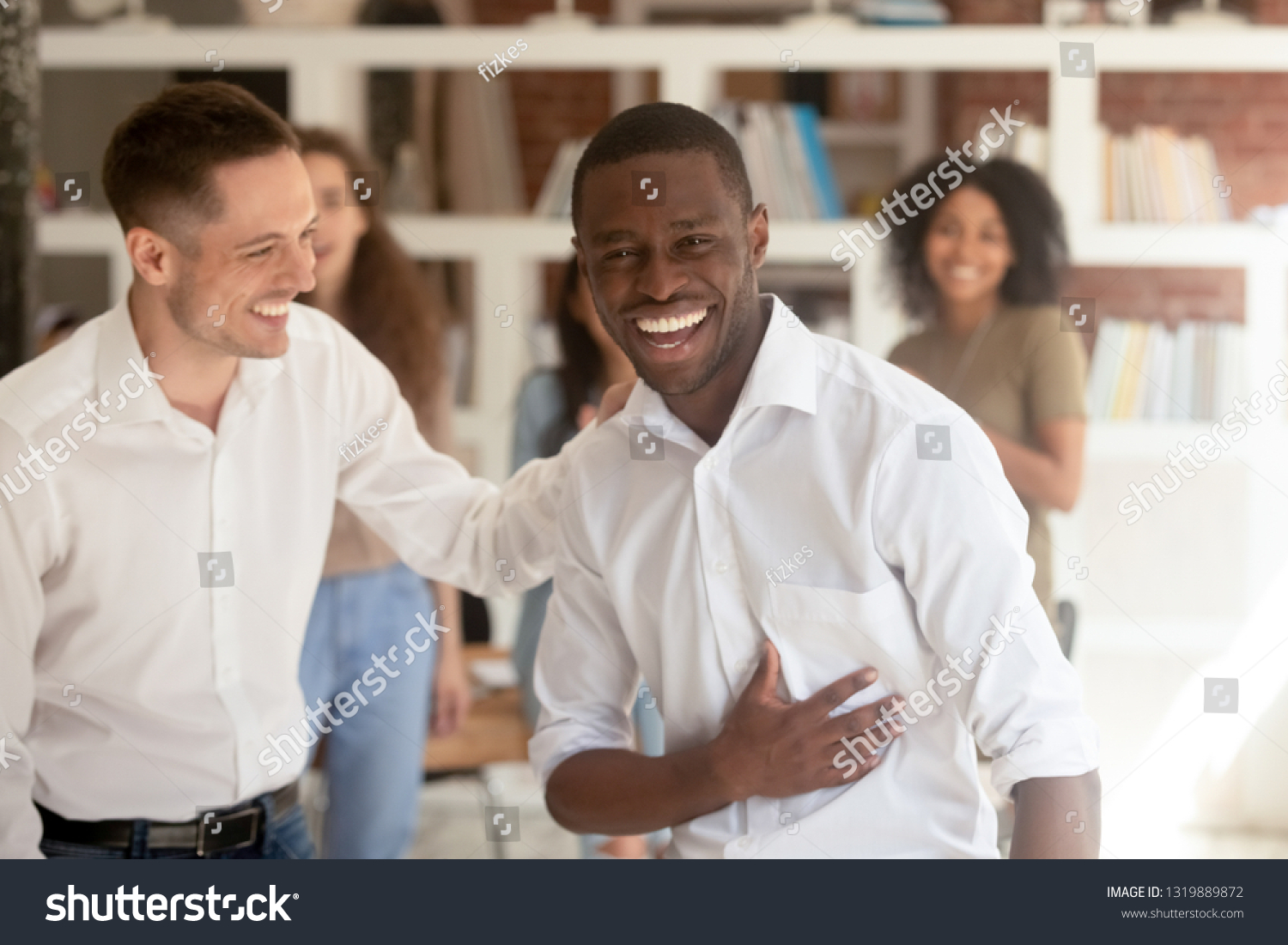 Successful proud black businessman looking at camera celebrating victory got promotion or reward, happy african employee taking congratulations from colleague on professional achievement in office #1319889872