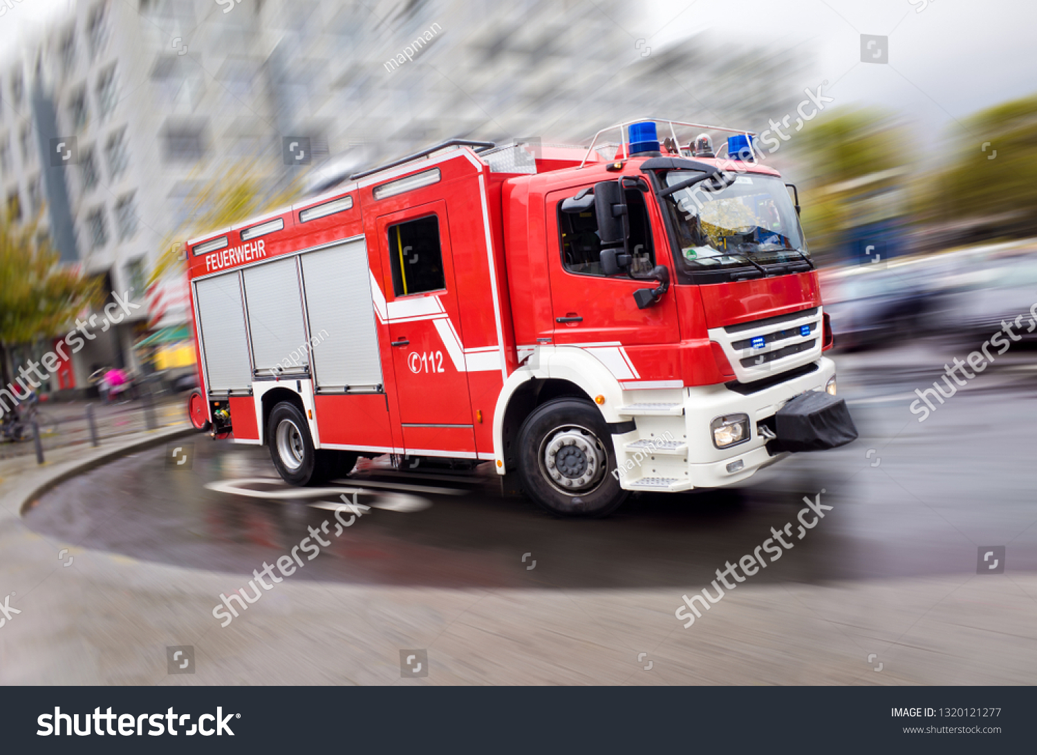 Fire engine driving fast on a road in an emergency #1320121277