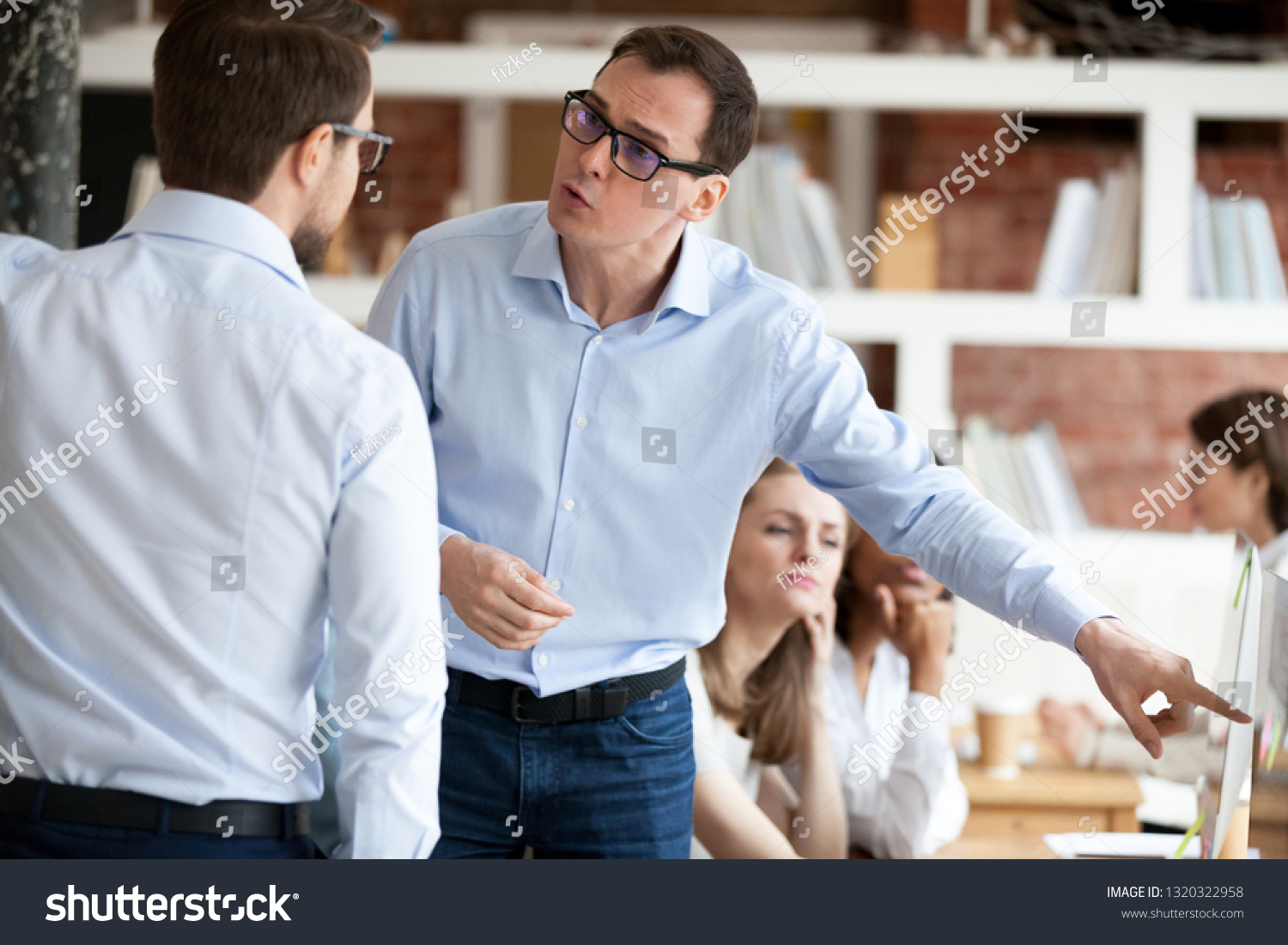 Indignant men colleagues quarrelling in shared office, having different opinion and disagreements arguing at work. Mad millennial employee accusing business partner disputing at coworking modern room #1320322958