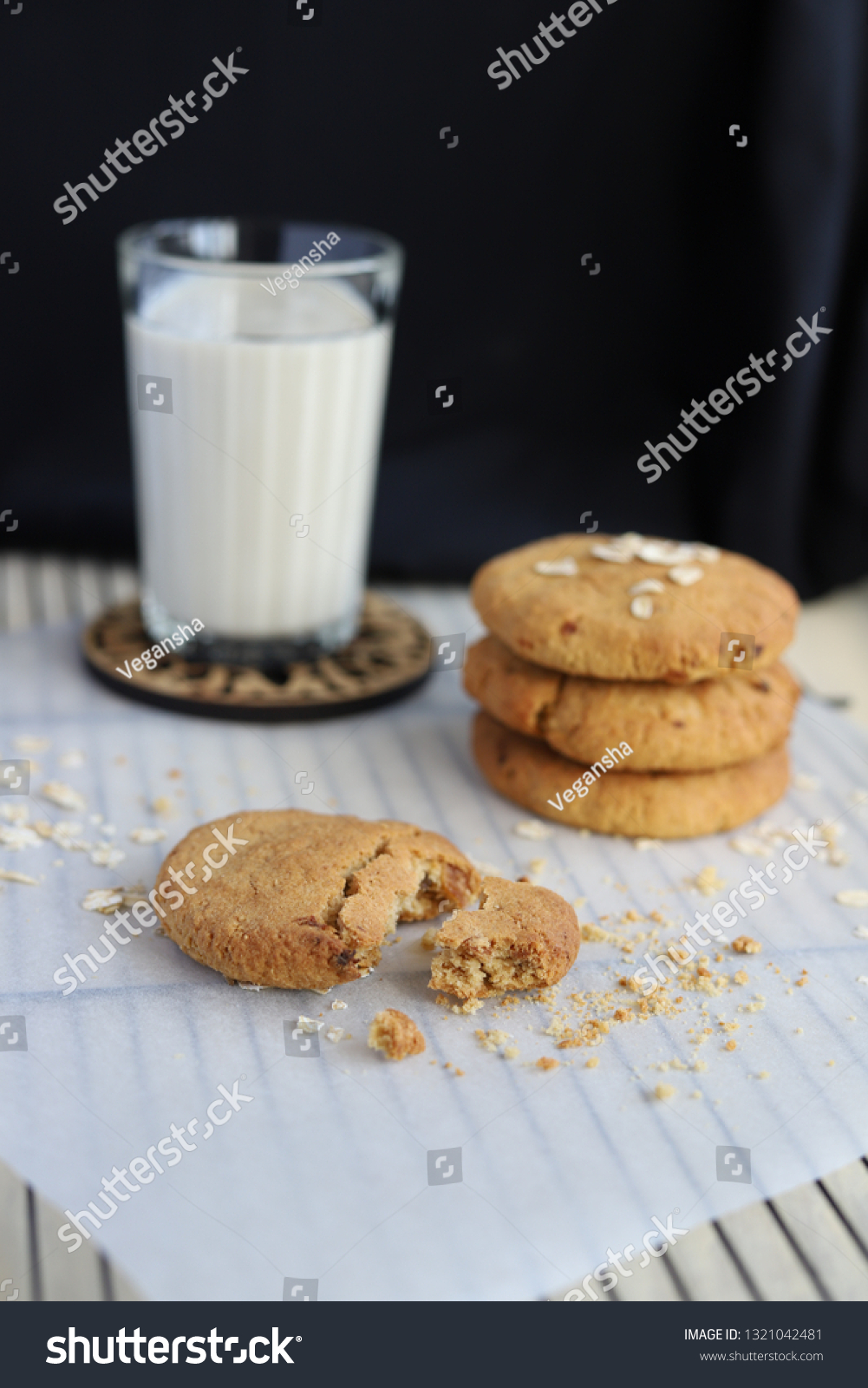 Vegan oat cookies with the glass of oat milk on the dark background #1321042481