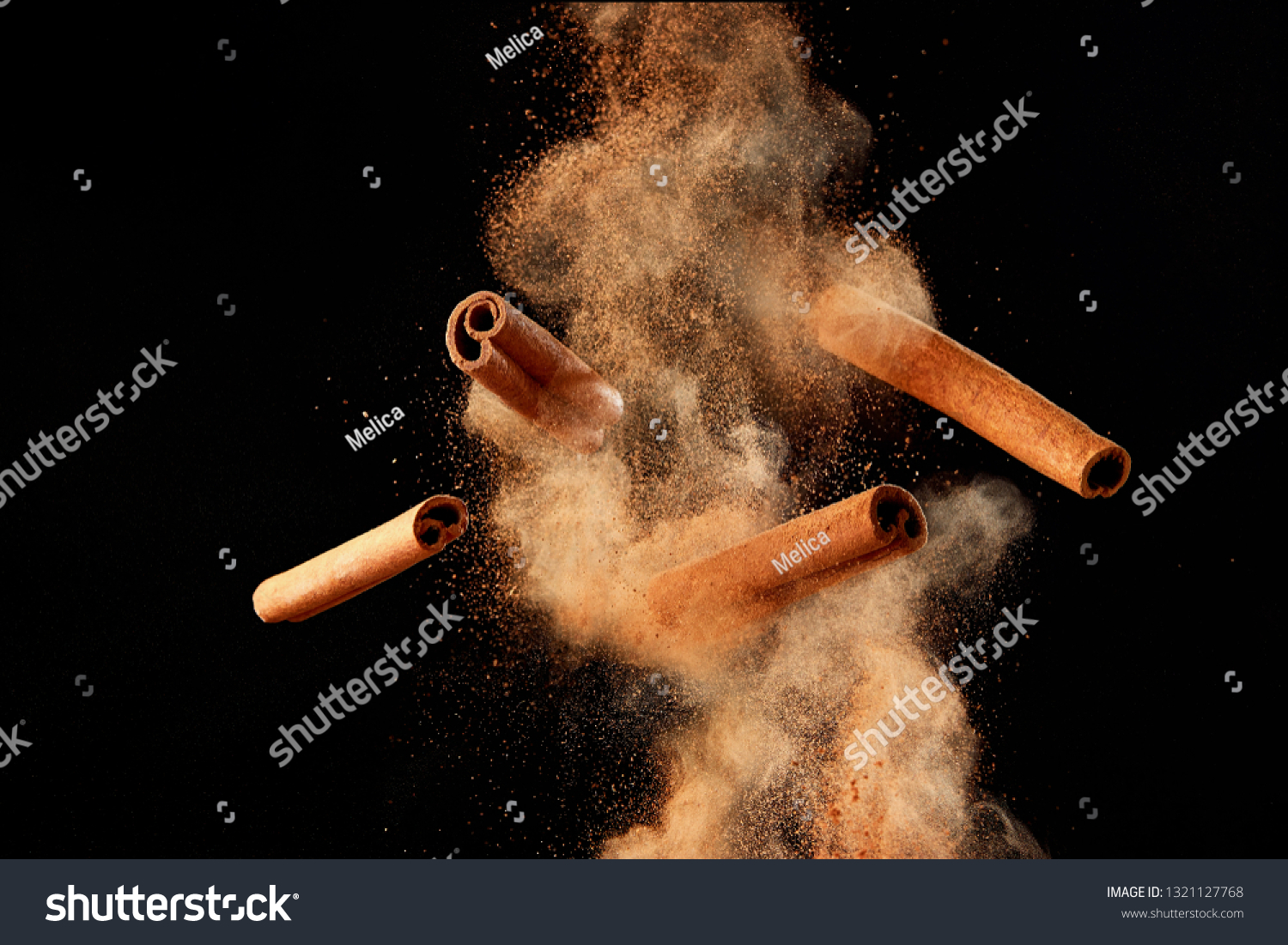 Food explosion with cinnamon sticks and powder, on black background. #1321127768