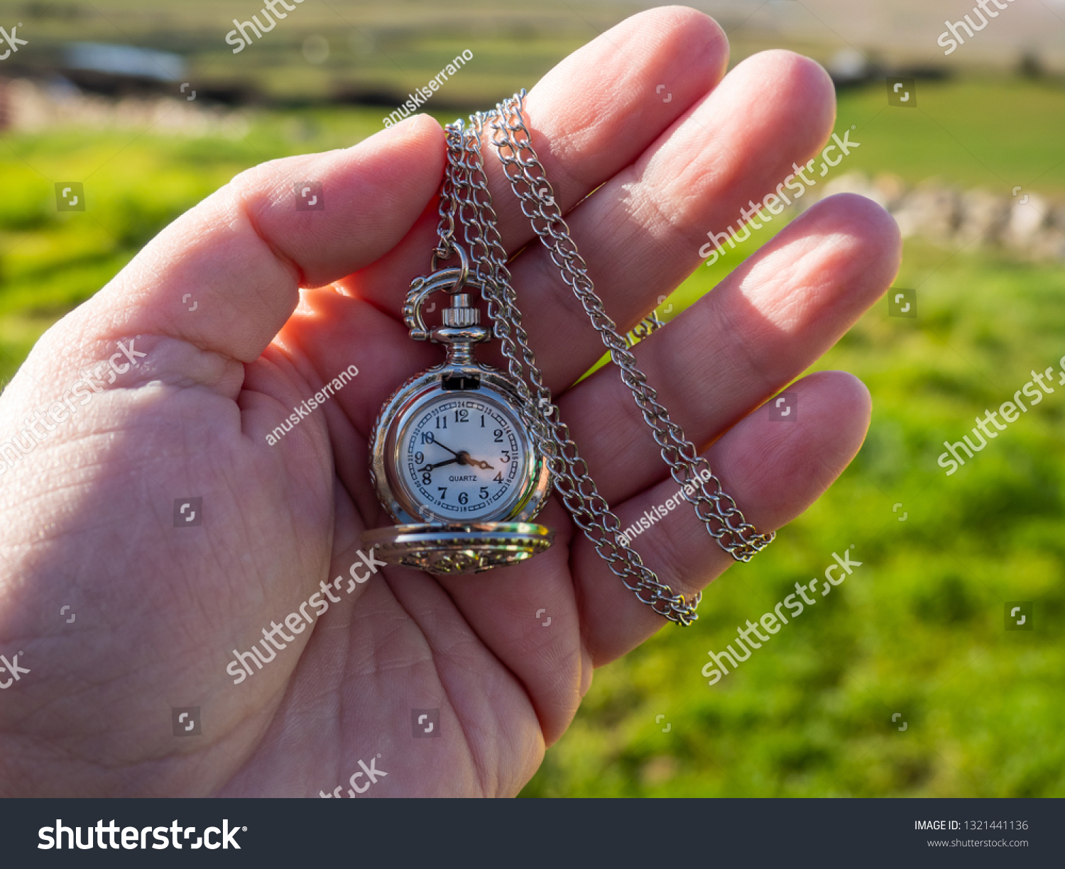 One person with one antique chain watch plated in his hand #1321441136