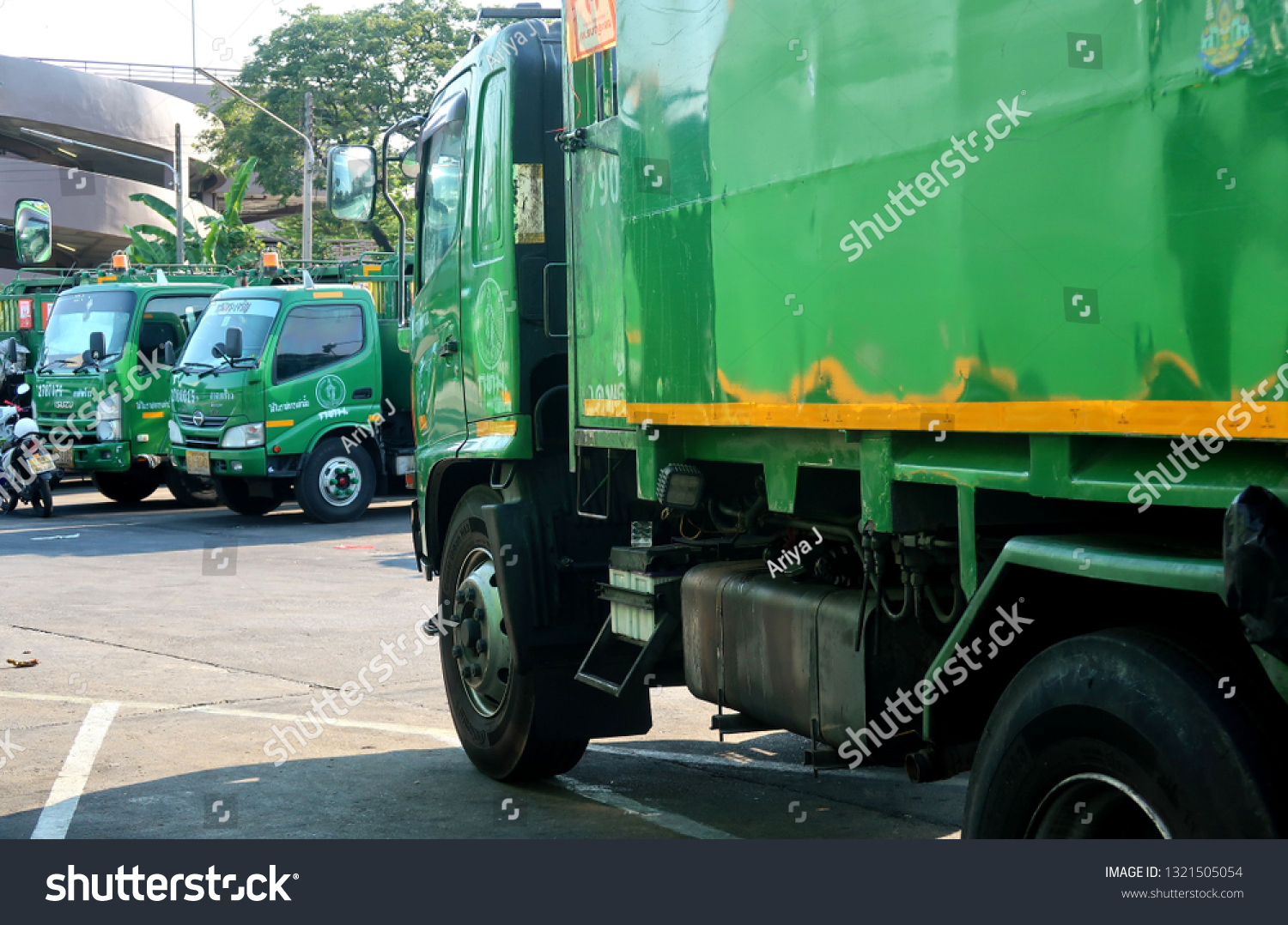 Bangkok/Thailand - February 22,2019 : Green garbage trucks in Bangkok city #1321505054
