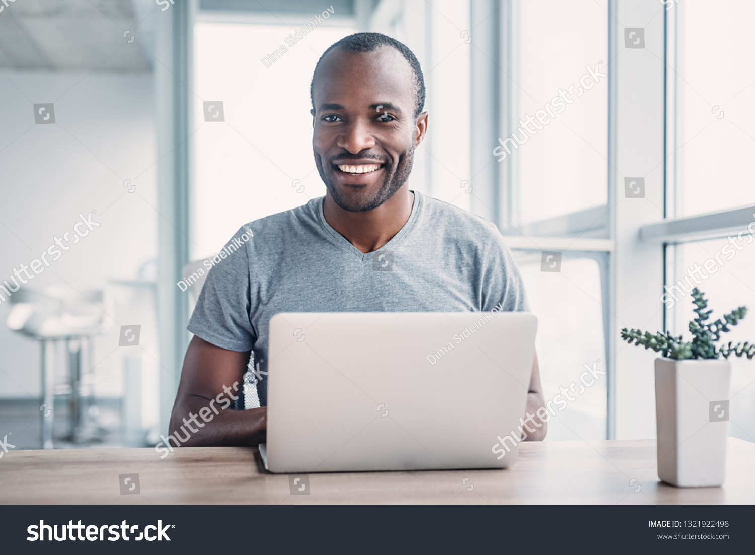 Young businessman working on his laptop in office. #1321922498