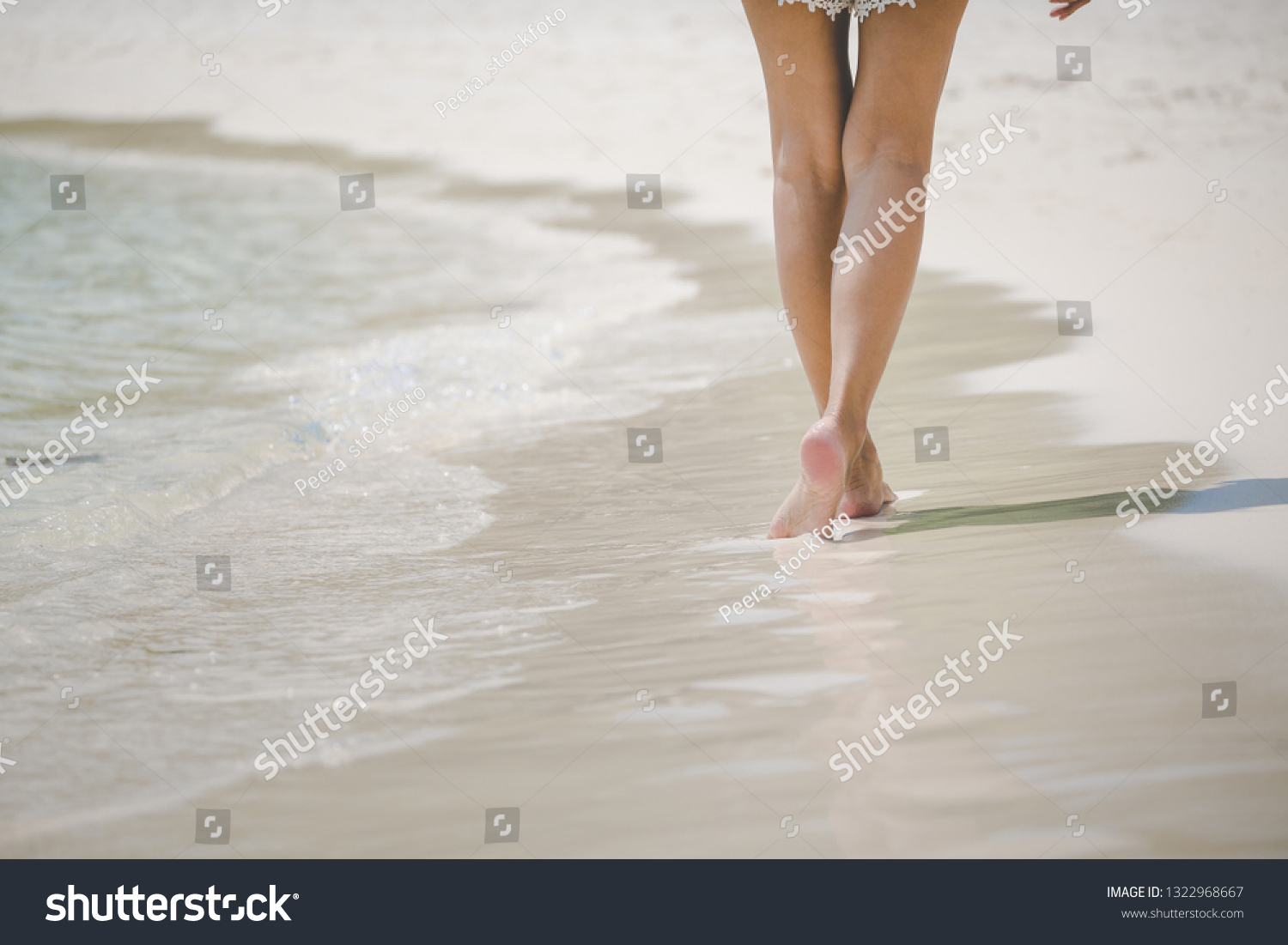 Closeup travel woman foot of walking on beach with sea wave in summer, holidays background, vacation concept #1322968667