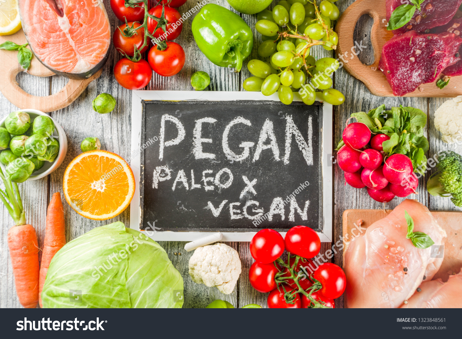 Trendy pegan diet - vegan plus paleo diet food concept, many fresh vegetables, fruits, raw beef and chicken meat, salmon fish, white wooden background top view copy space #1323848561