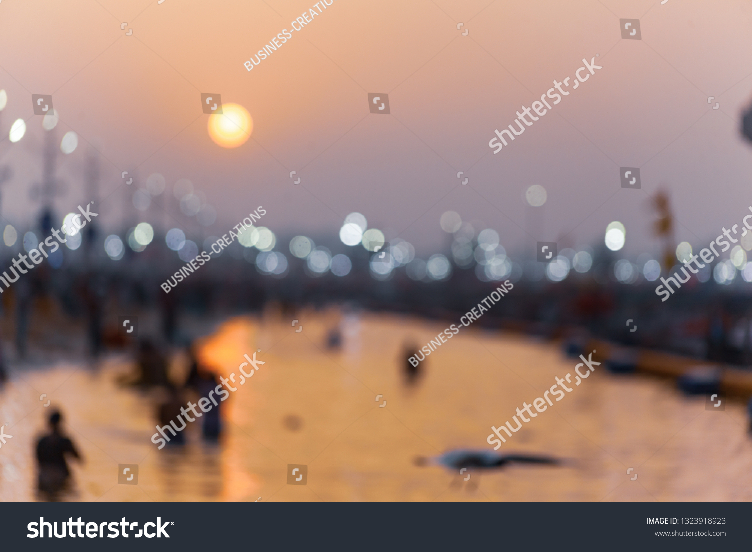 Defocoused scene of beautiful sunrise with reflection on river water at Allahabad (India) Kumbh 2019. #1323918923