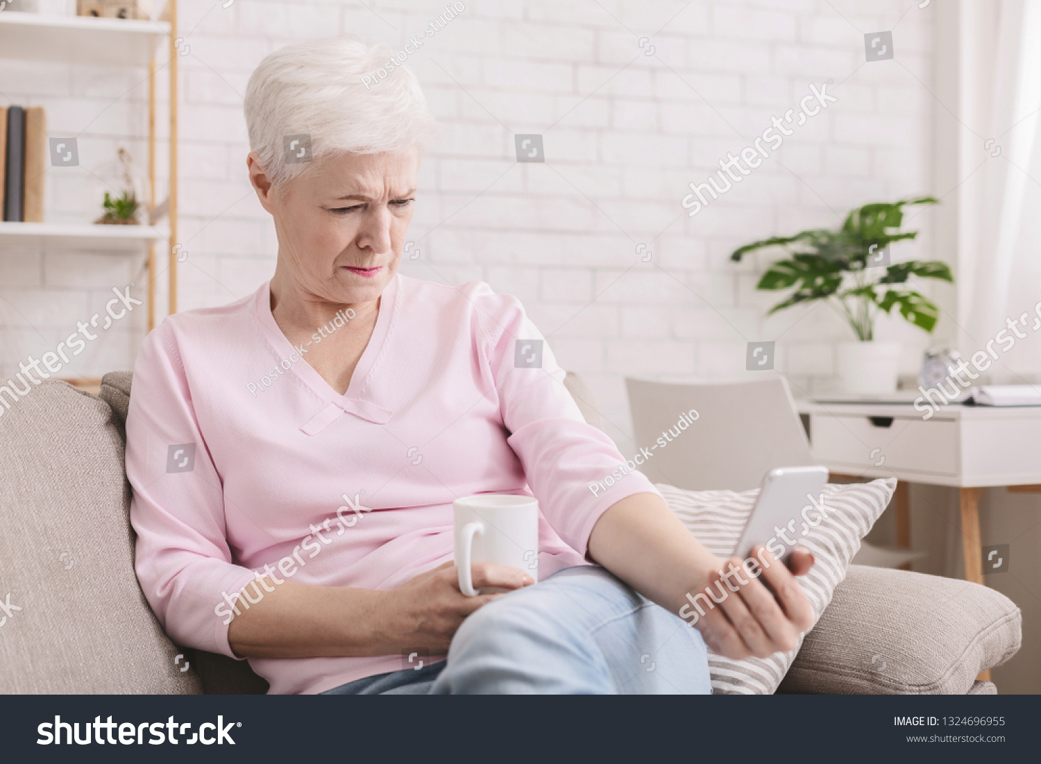Hyperopia. Woman squinting and holding phone far from eyes, reading smartphone screen #1324696955