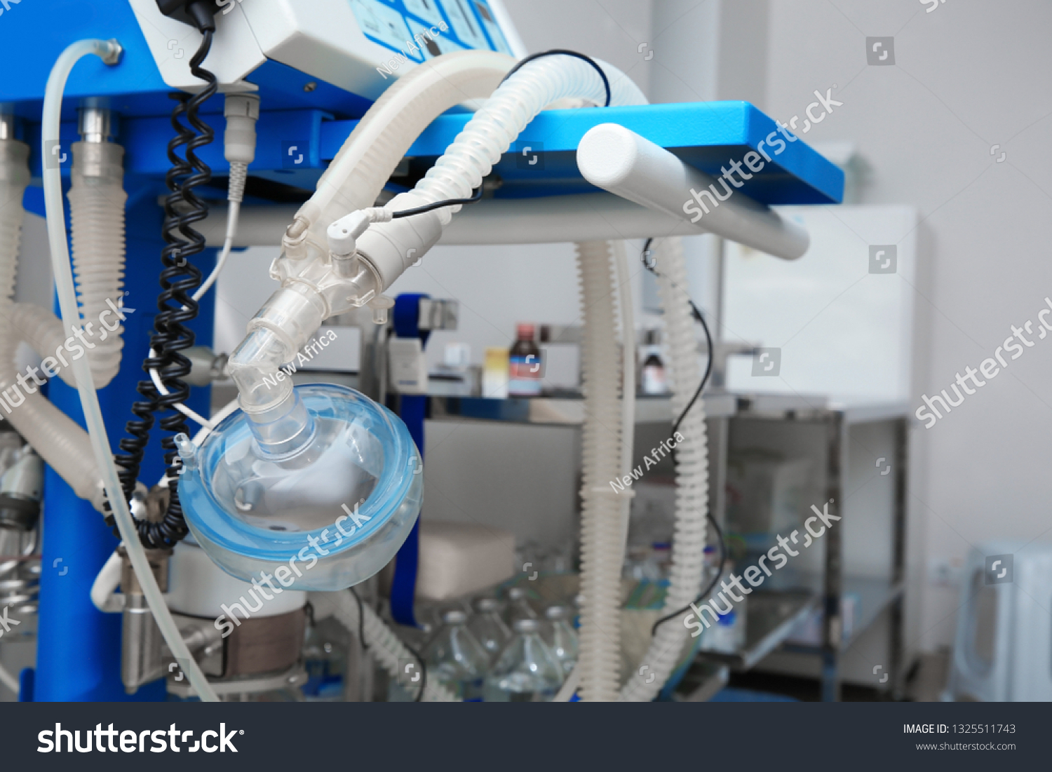 Oxygen mask as part of artificial lungs ventilation machine in surgery room, closeup. Space for text #1325511743